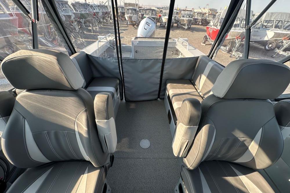 Interior of 2025 Hewescraft 210 Sea Runner ET boat with gray seating and spacious layout.