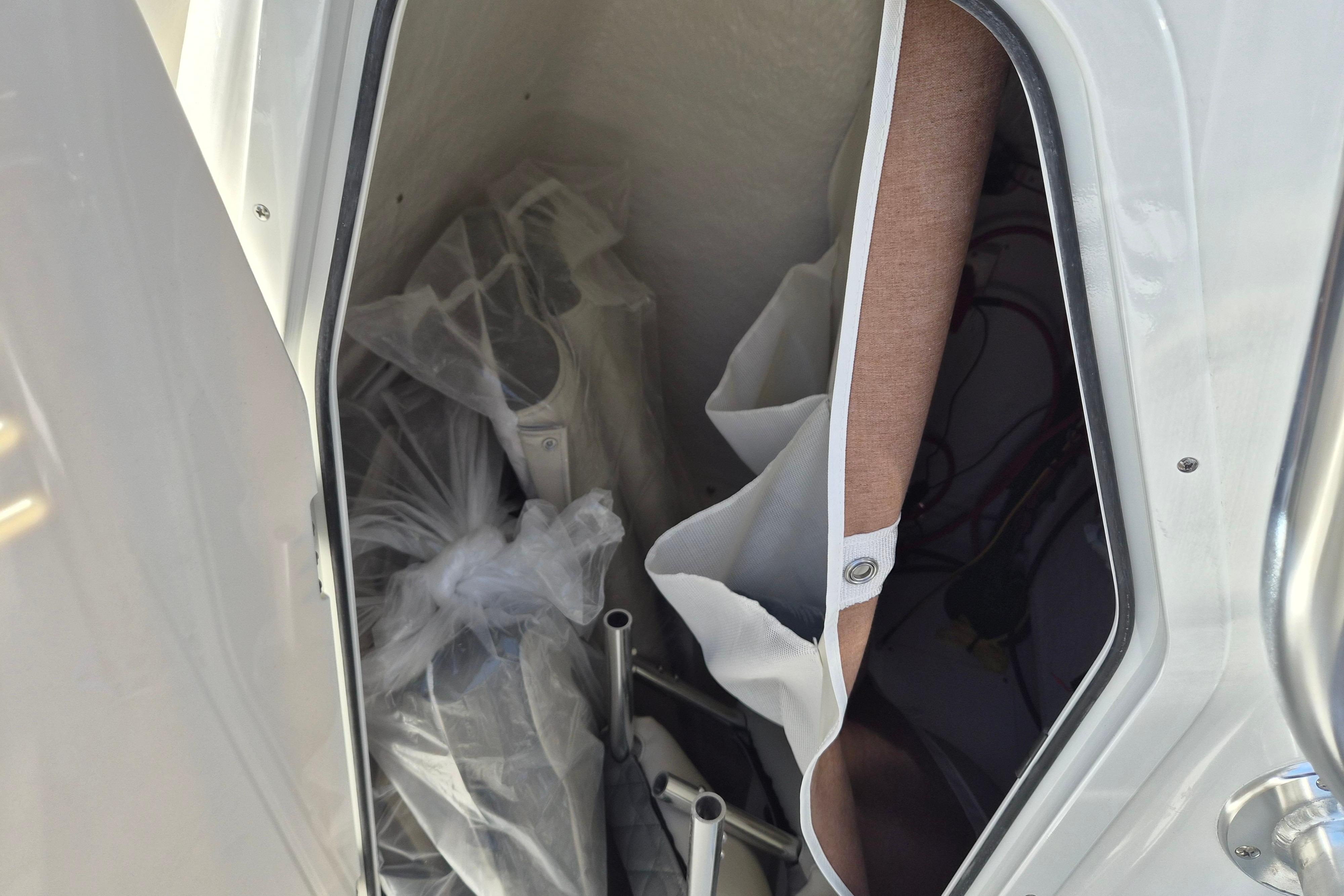 Storage compartment of 2026 Key West 239 FS boat with equipment and accessories.