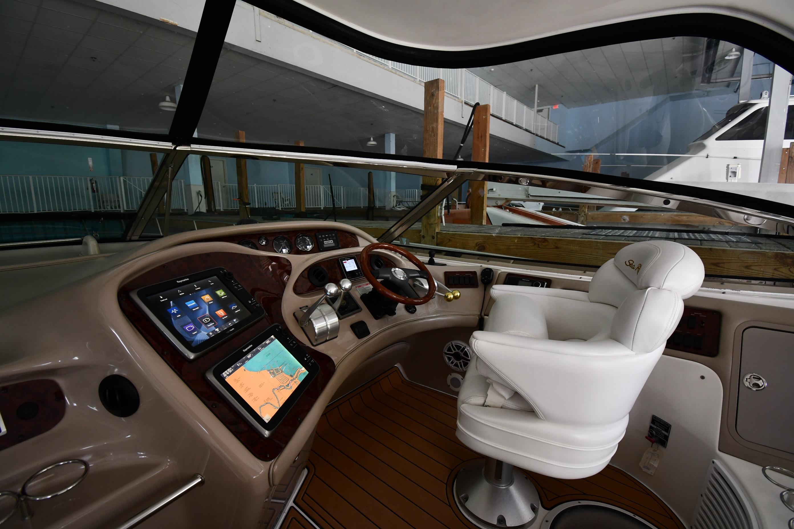 Luxurious helm of 2001 Sea Ray 540 Sundancer yacht with modern navigation equipment.