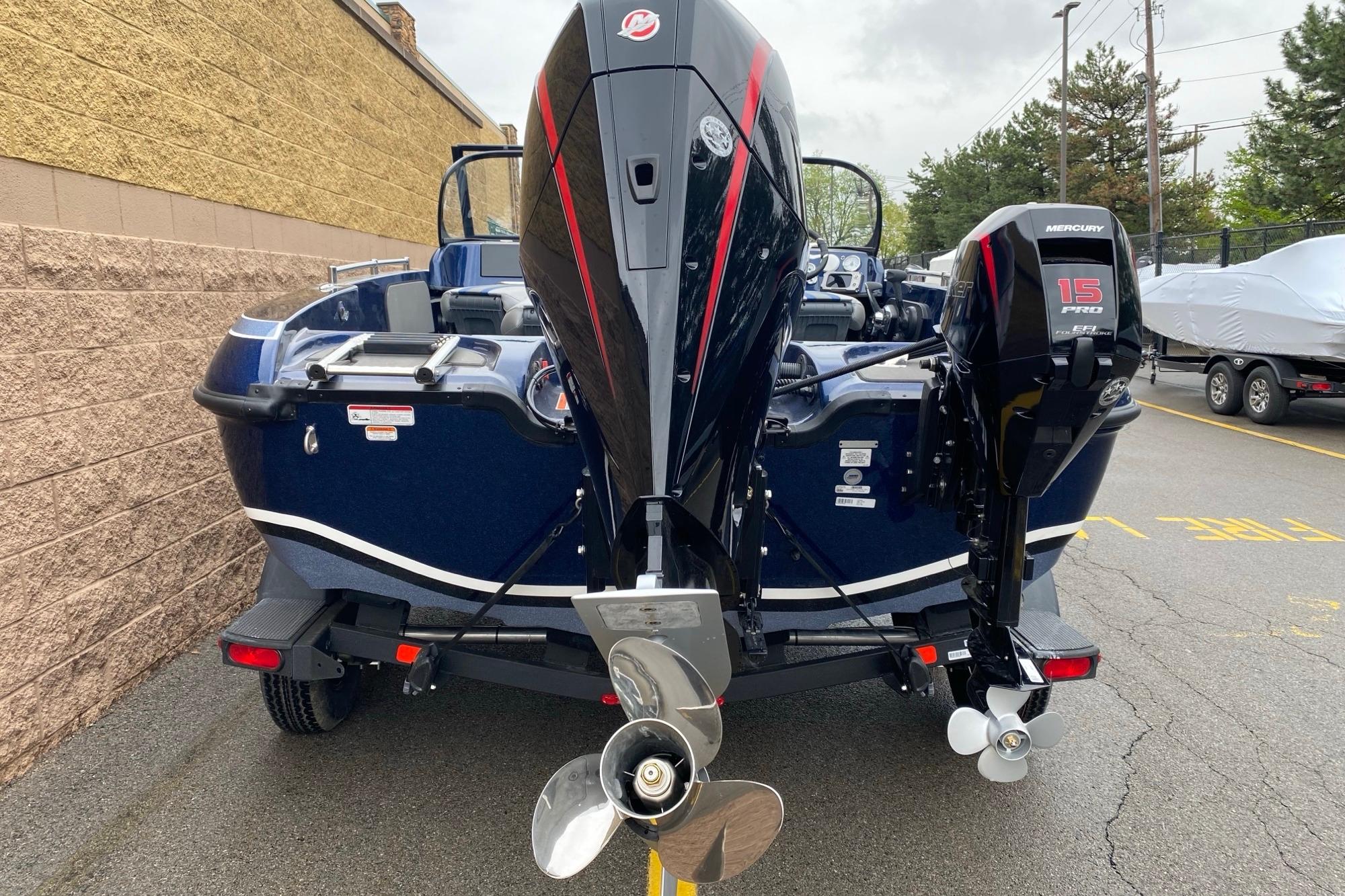2026 Nitro ZV19 Pro boat with dual Mercury engines, parked outdoors.