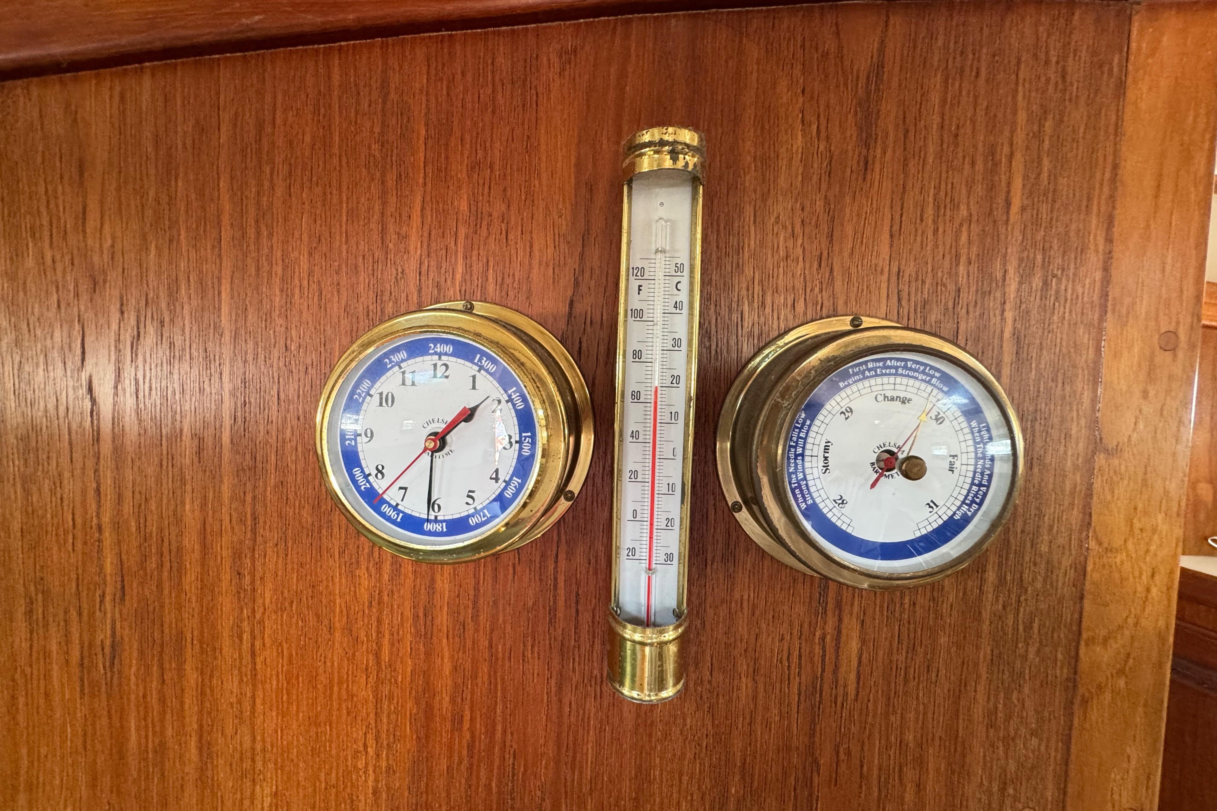 Nautical instruments on 1989 Cape Dory 30 Motorsailer, featuring clock, barometer, and thermometer.