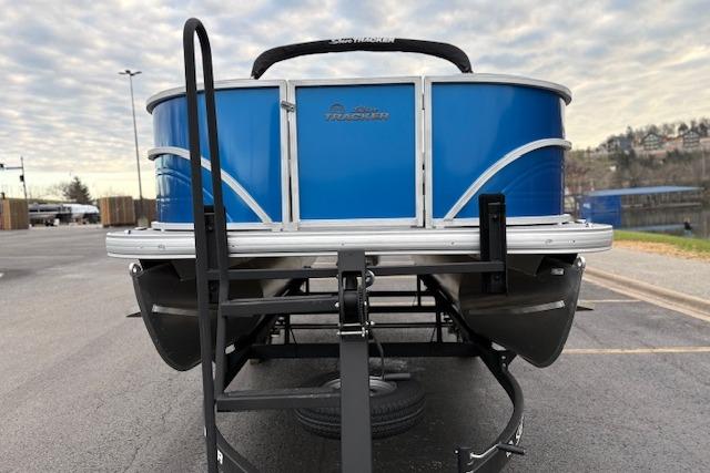 2026 Sun Tracker Party Barge 16 DLX pontoon boat on trailer, blue exterior.