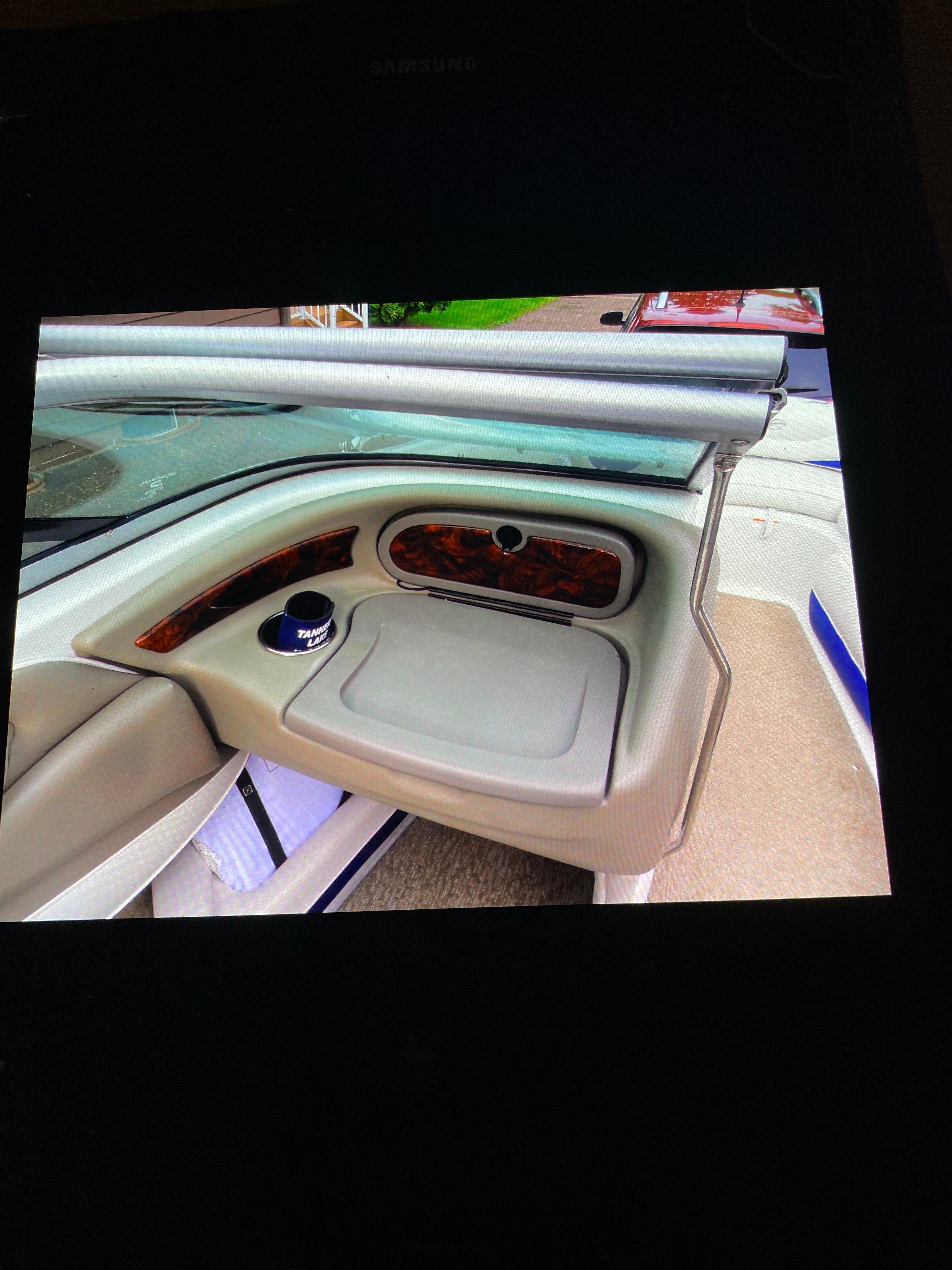 Interior view of a Crownline 21 bow rider with sleek seating and wood paneling.