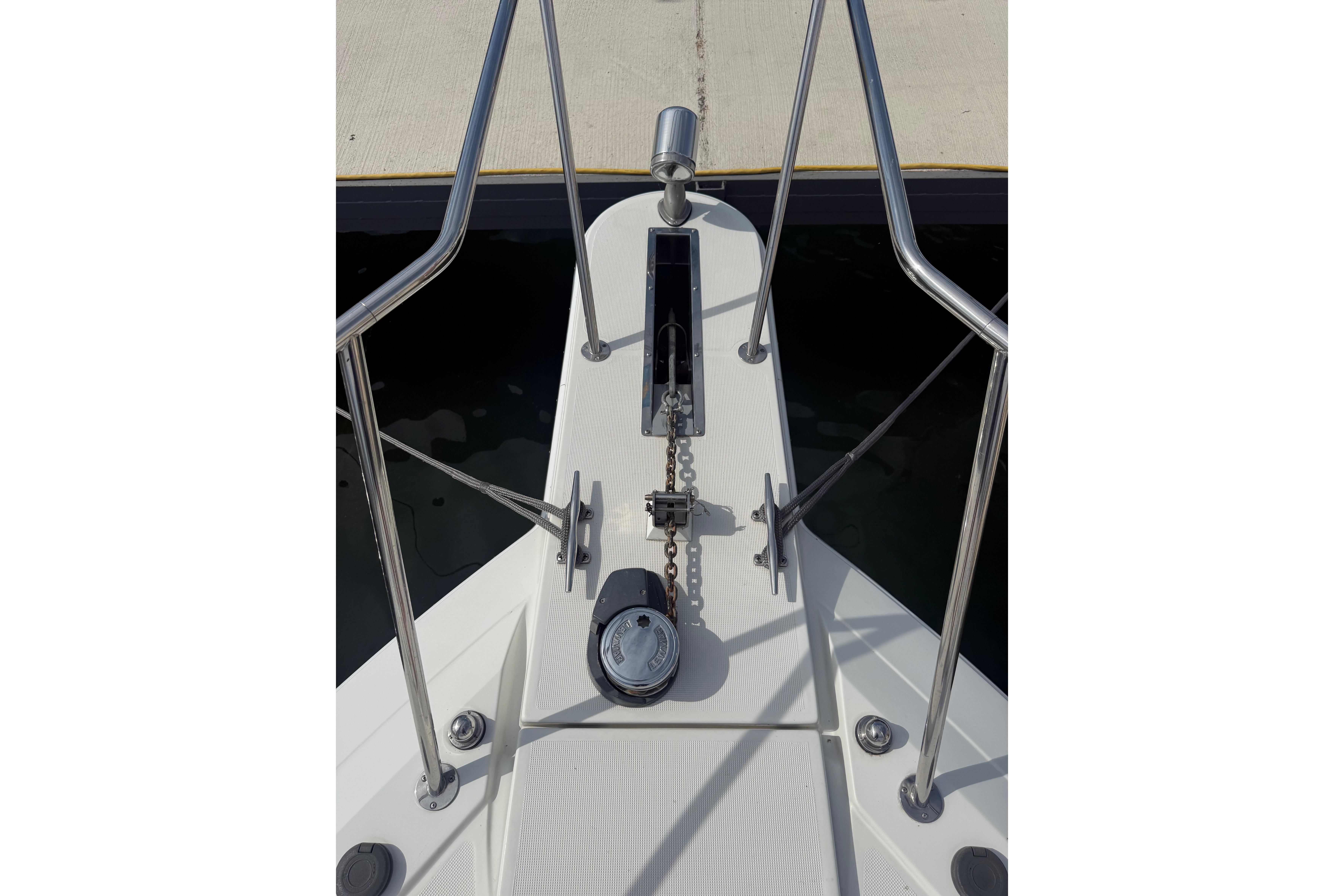 Bow of 1999 Formula 34 Performance Cruiser with anchor chain and railing.