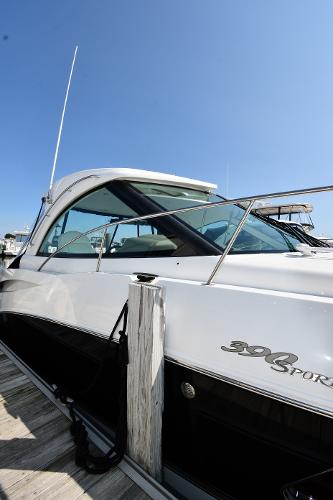 2010 Cruisers Yachts 390 Sports Coupe docked, showcasing sleek design and modern features.