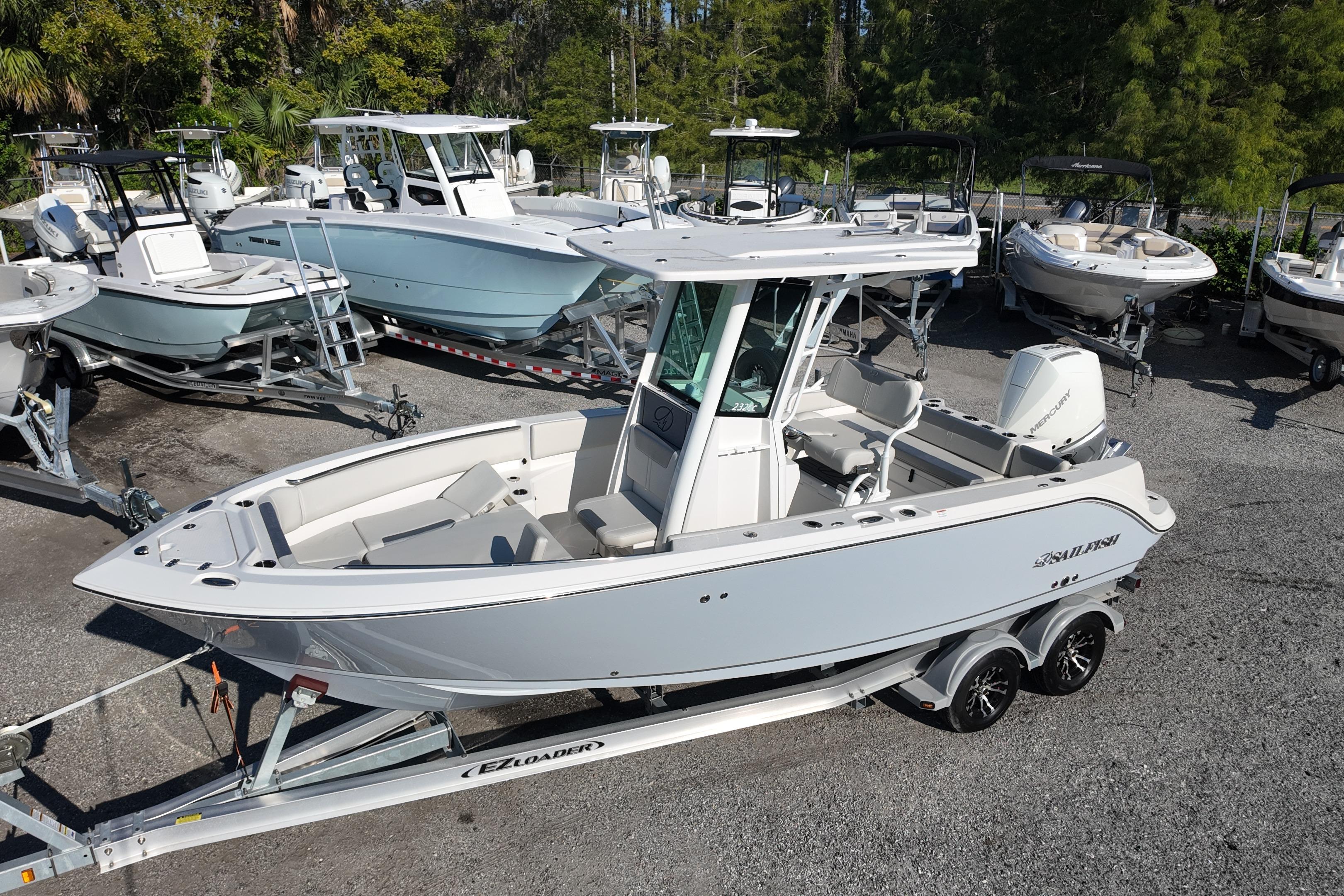 2026 Sailfish 232 CC boat on trailer, surrounded by other boats in a marina.