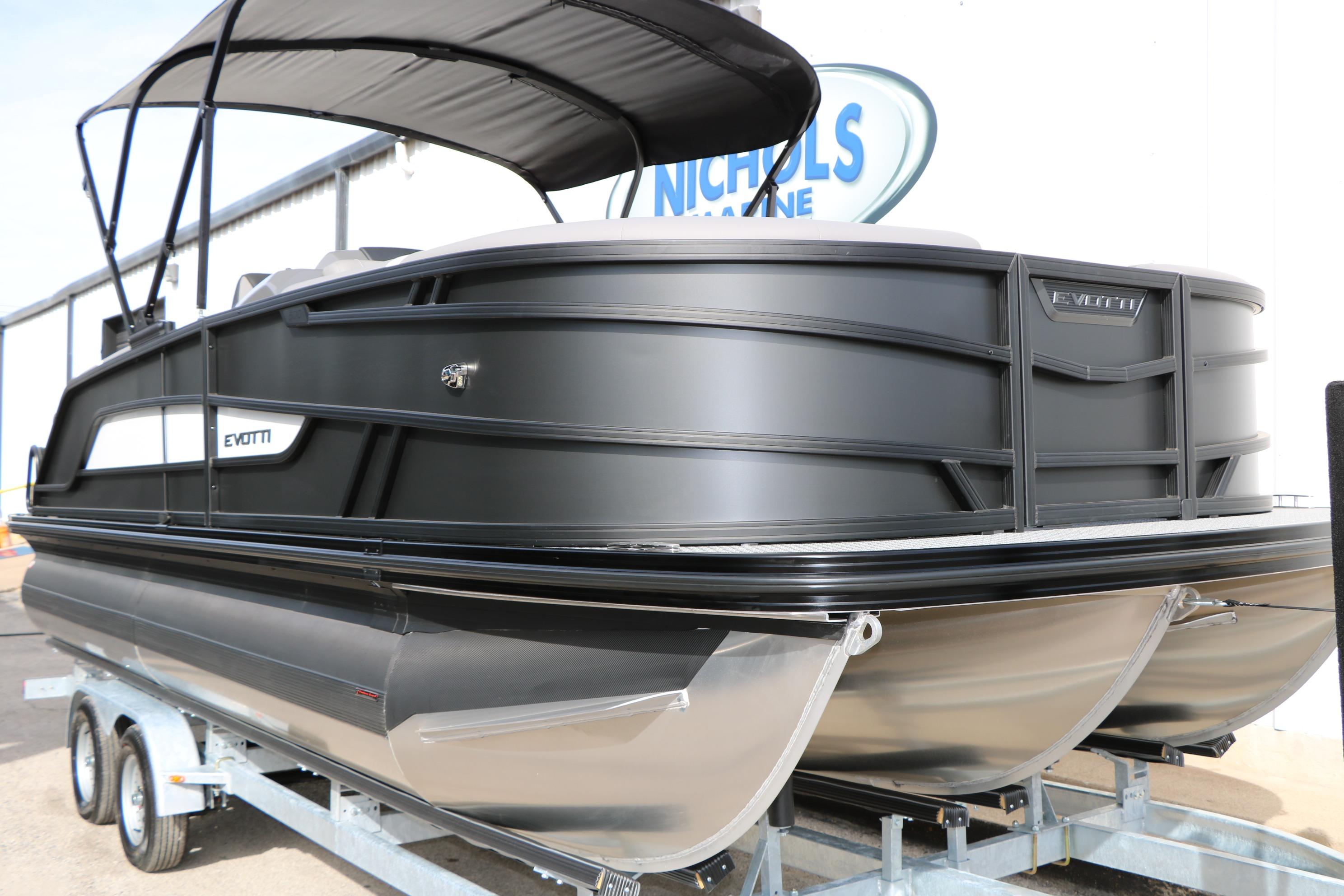2026 Evotti 521QL pontoon boat on trailer, sleek black design, outdoor setting.