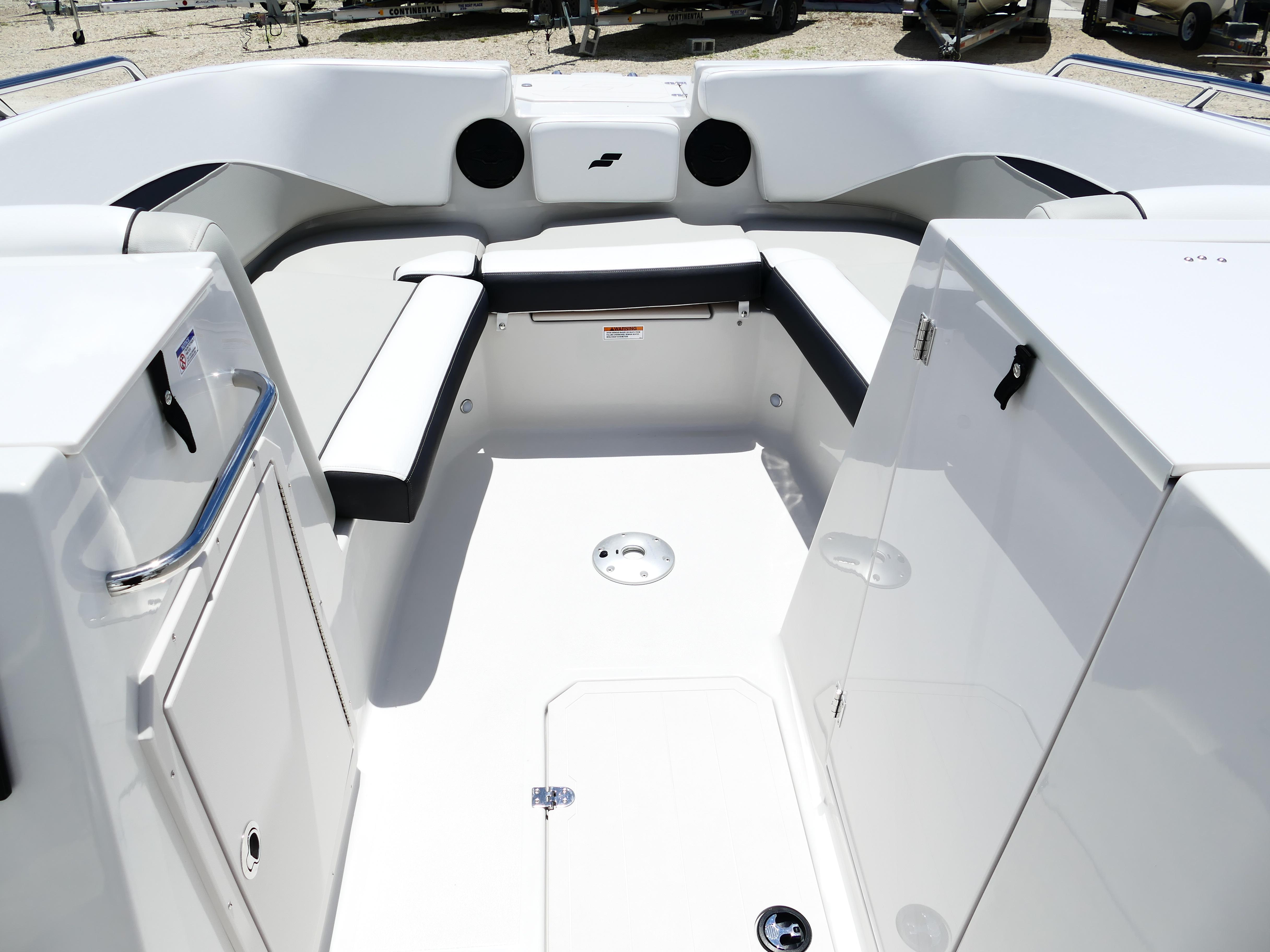 2026 Starcraft SVX 231 OB DH boat interior with white seating and storage compartments.