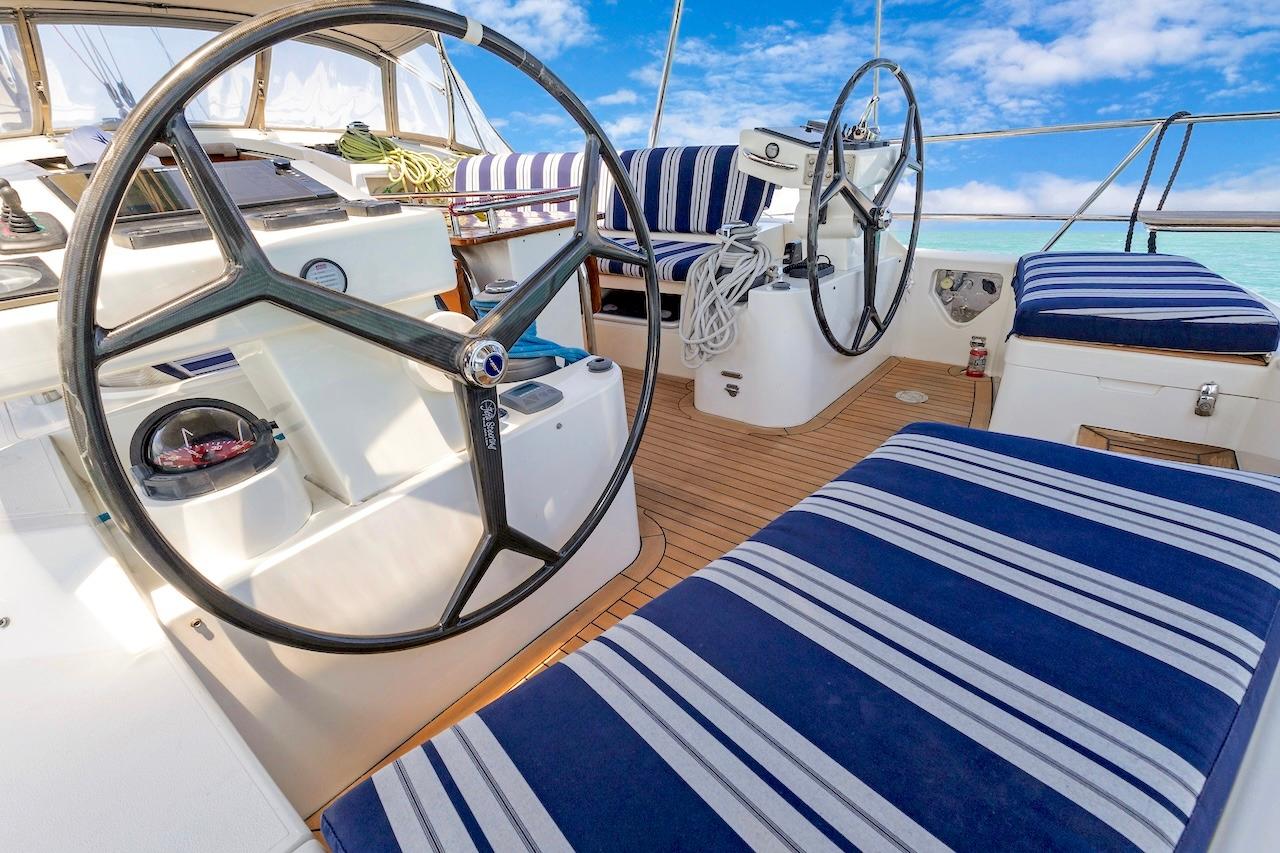 Cockpit of 2011 Southerly 57 RS yacht with striped seating and dual steering wheels.