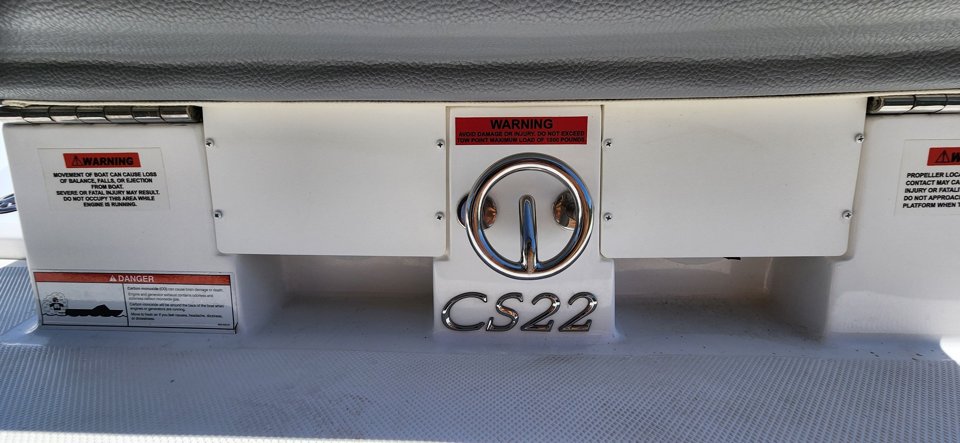 Close-up of the stern of a Cobalt CS22 boat with warning labels.