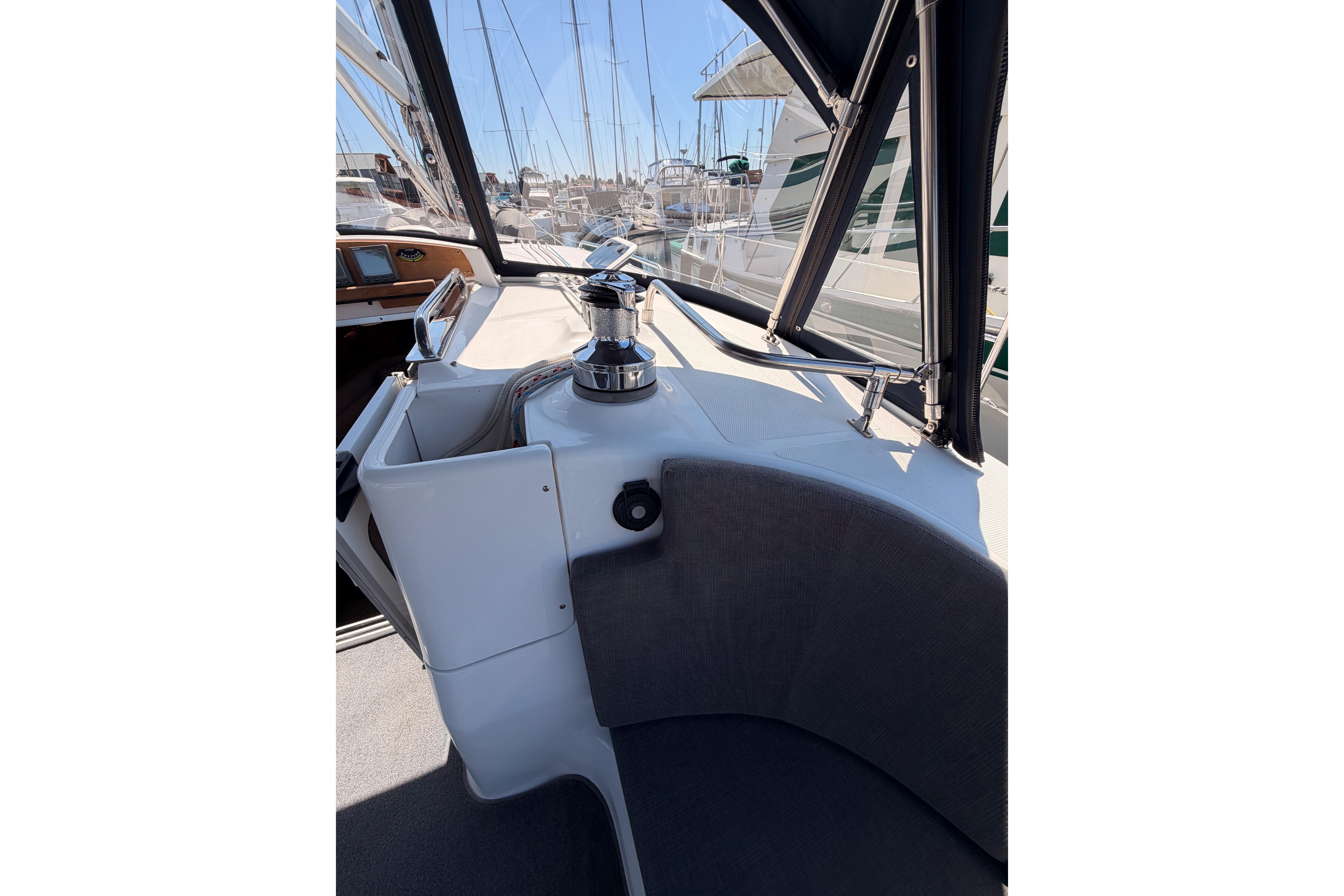 Interior view of 2008 Hunter 45 Deck Salon sailboat cockpit with winch and seating.
