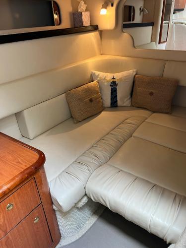 Interior of a 2001 Sea Ray 340 Sundancer with beige sofa.
