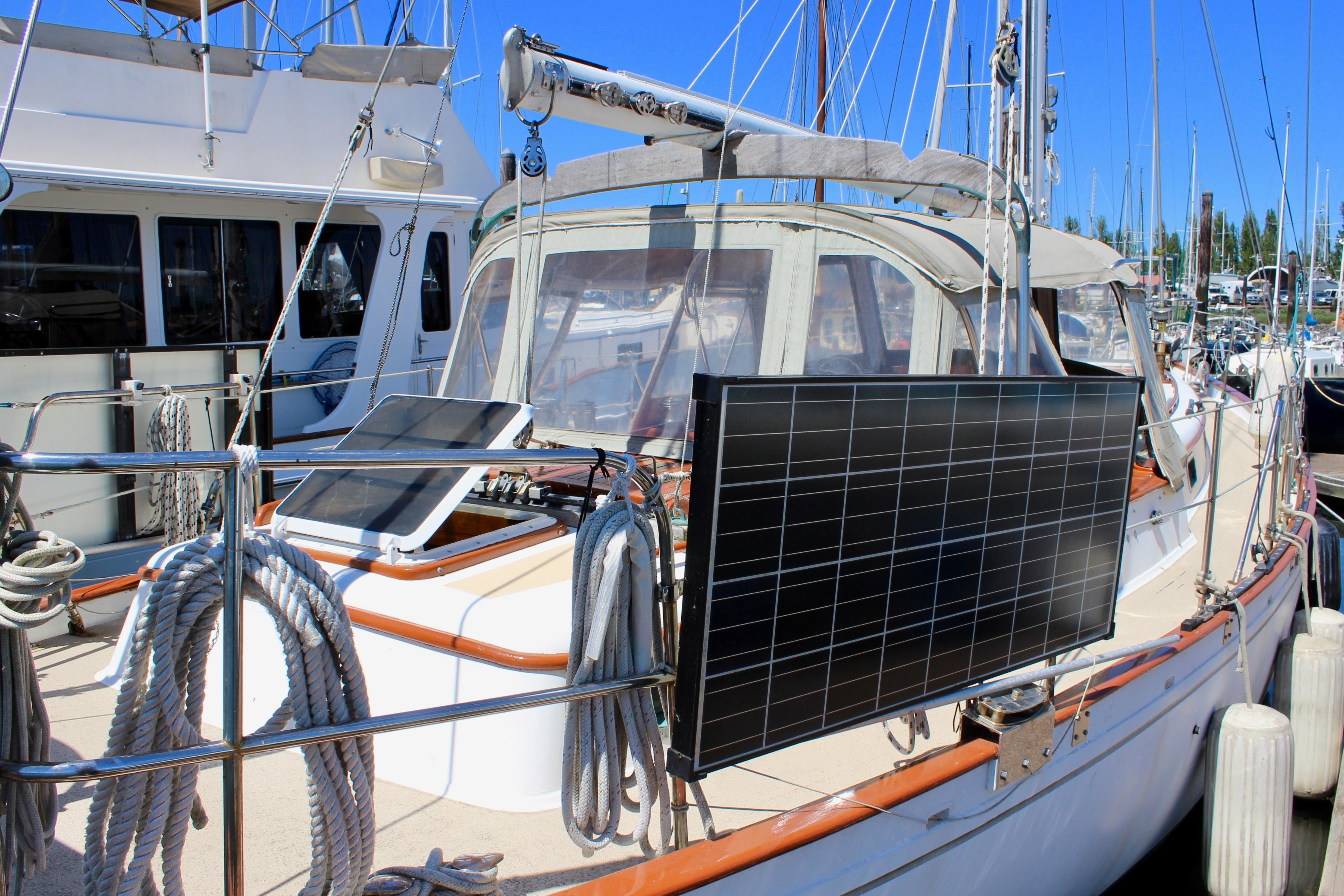 1981 Kelly Peterson 46 sailboat with solar panels docked at marina.