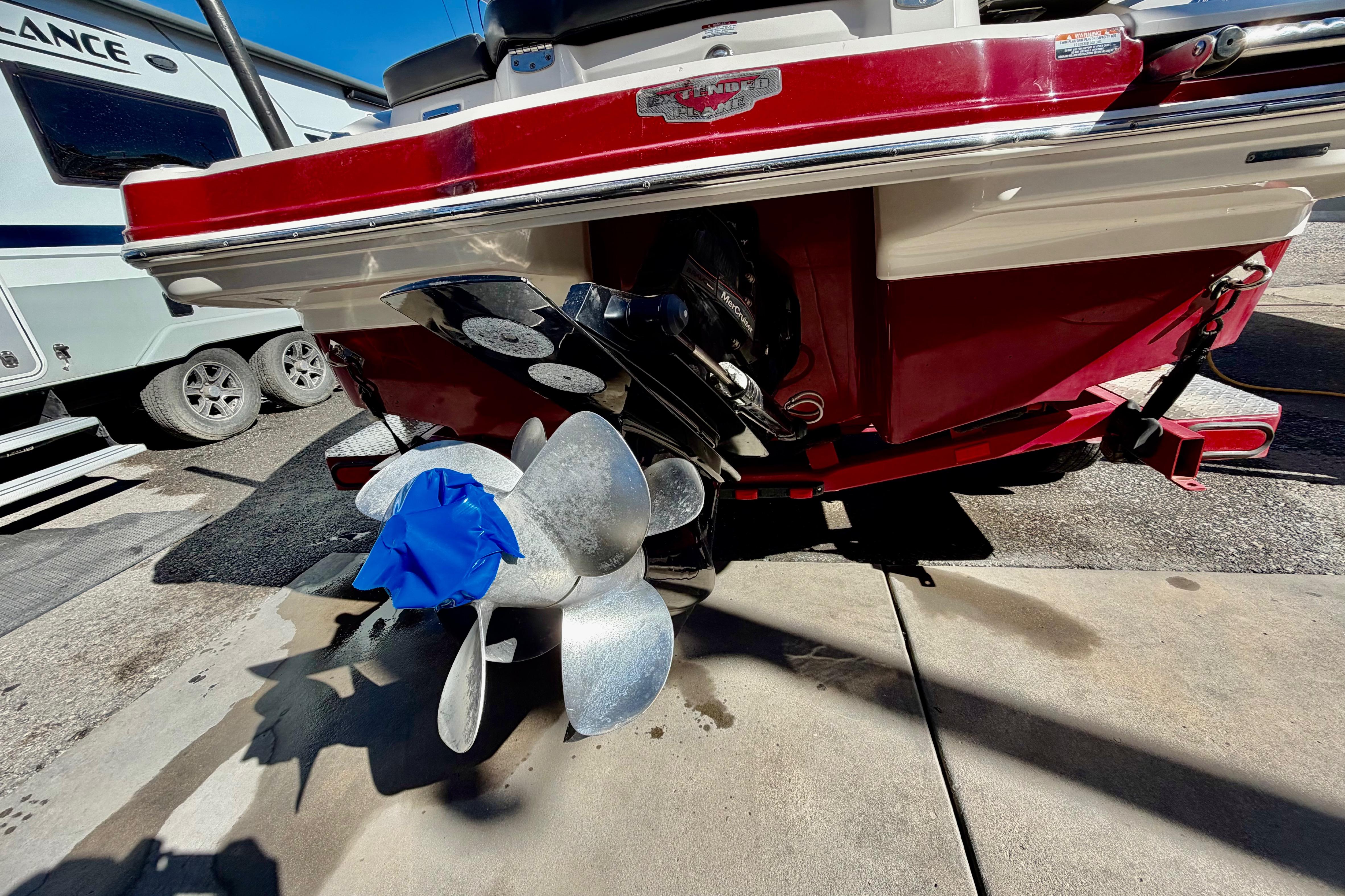 Rear view of a 2013 Chaparral 206 SSi boat with a covered propeller.