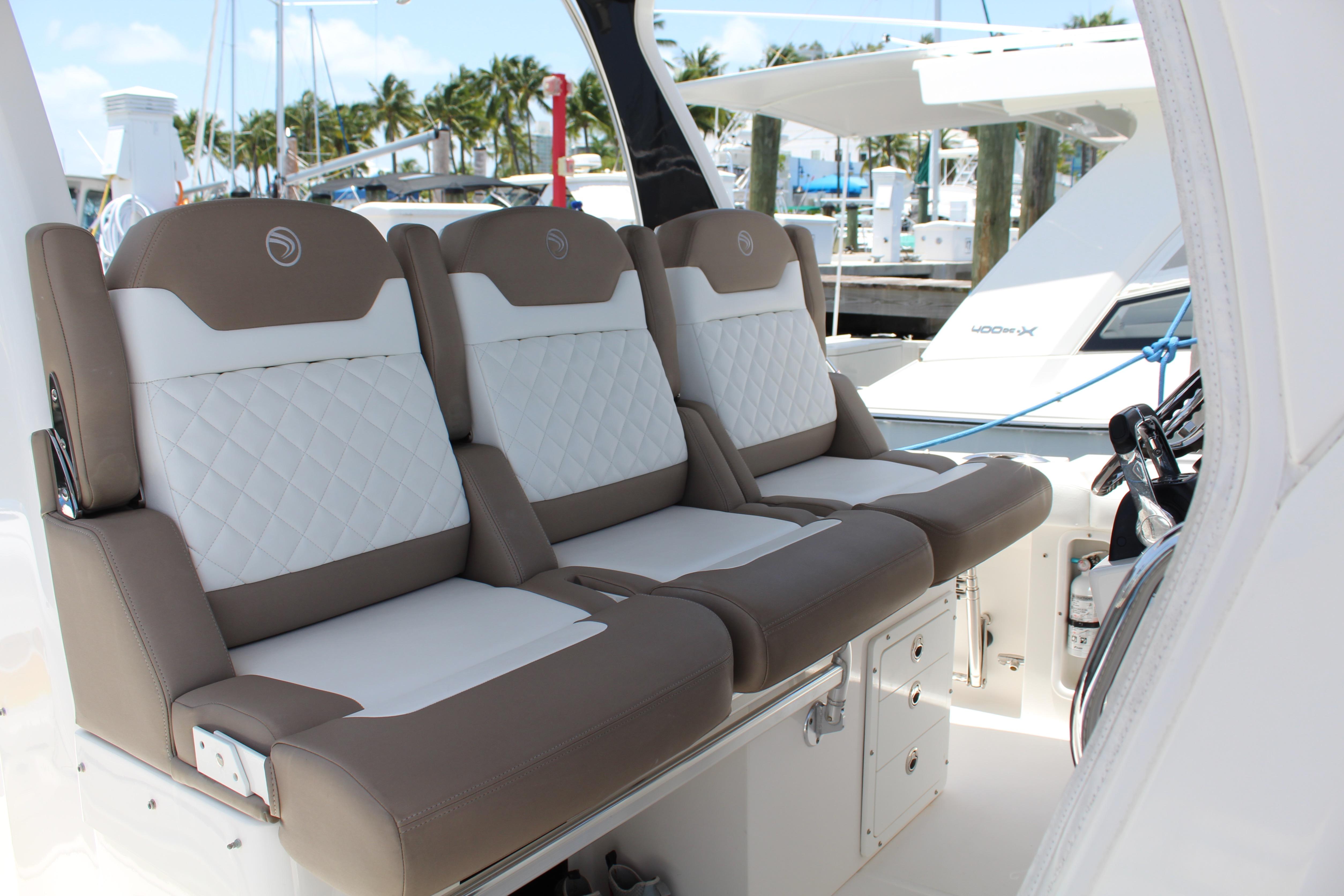 Luxurious seating on 2016 Edgewater 370CC boat, featuring elegant white and brown upholstery.