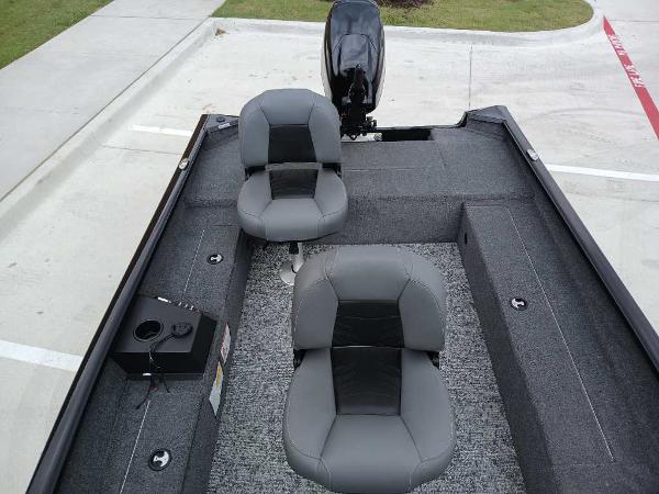 2025 Tracker Super Guide V-16 T boat interior with two gray seats and motor.