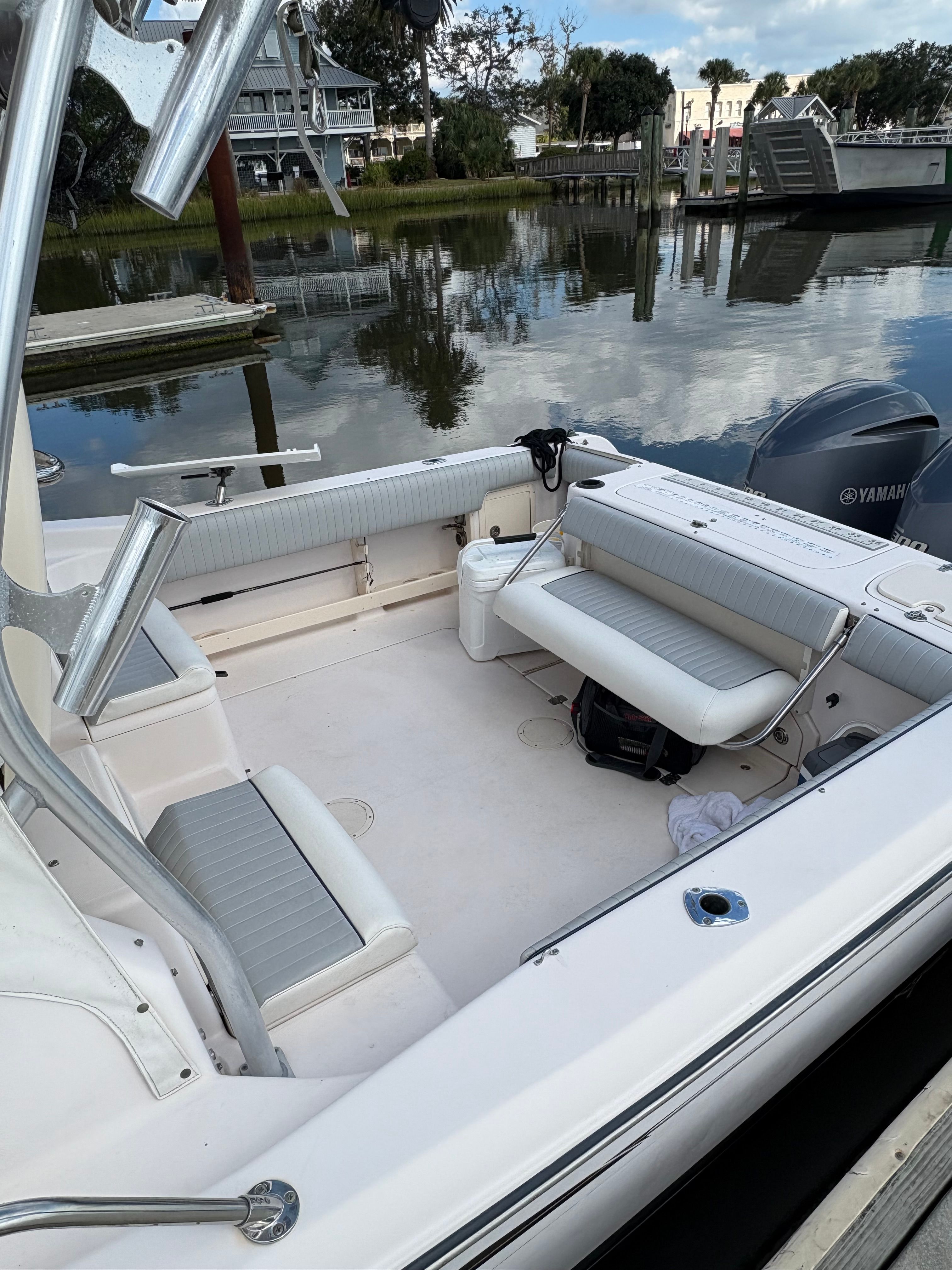 2009 Grady-White Chesapeake 290 boat docked by calm water.
