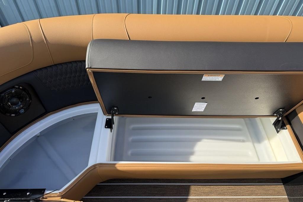 Open storage compartment in 2026 Premier 250 Solaris RS CL boat, featuring tan upholstery.