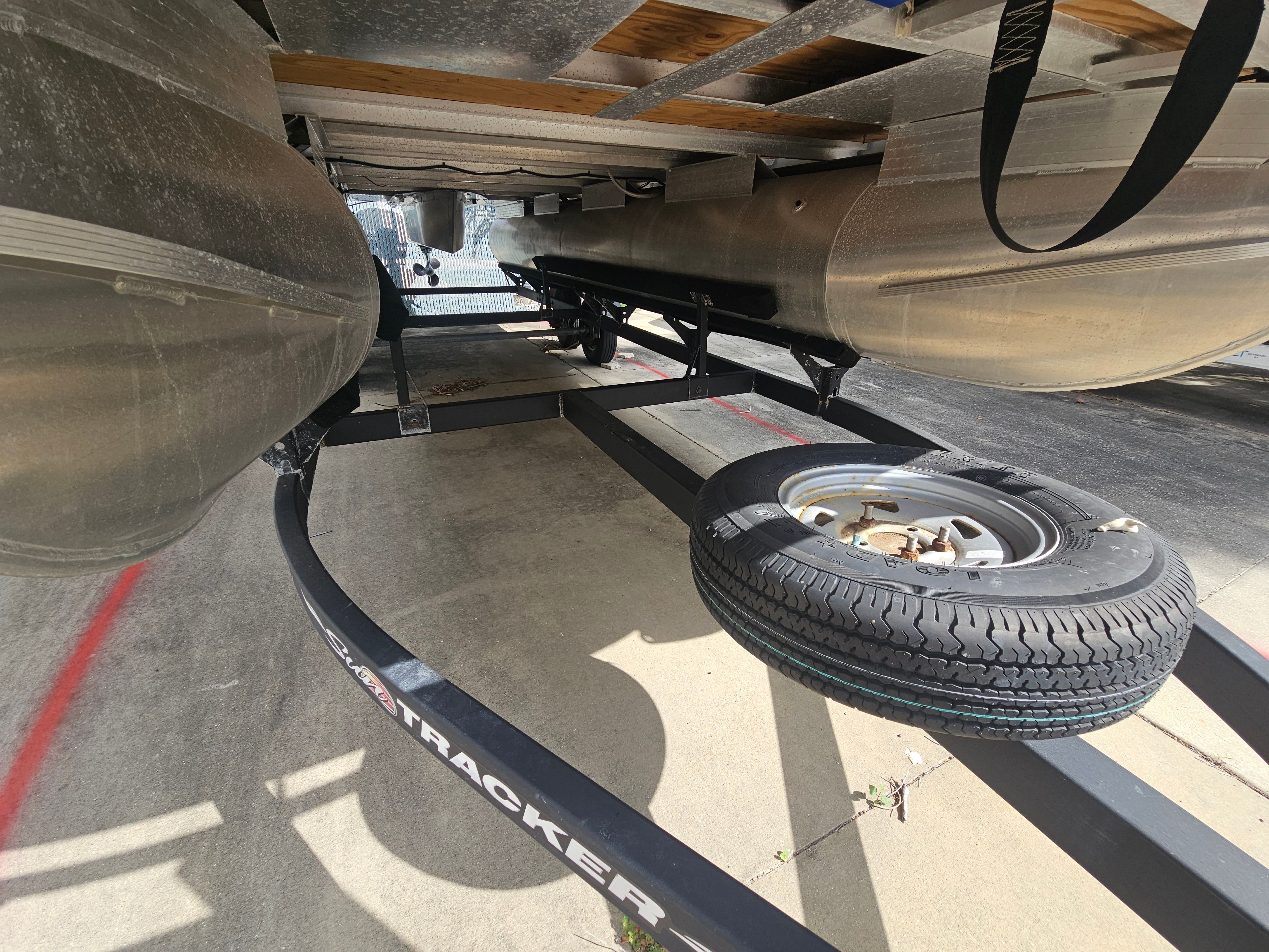 Underside of a 2024 Sun Tracker Fishin' Barge 22 DLX boat trailer.