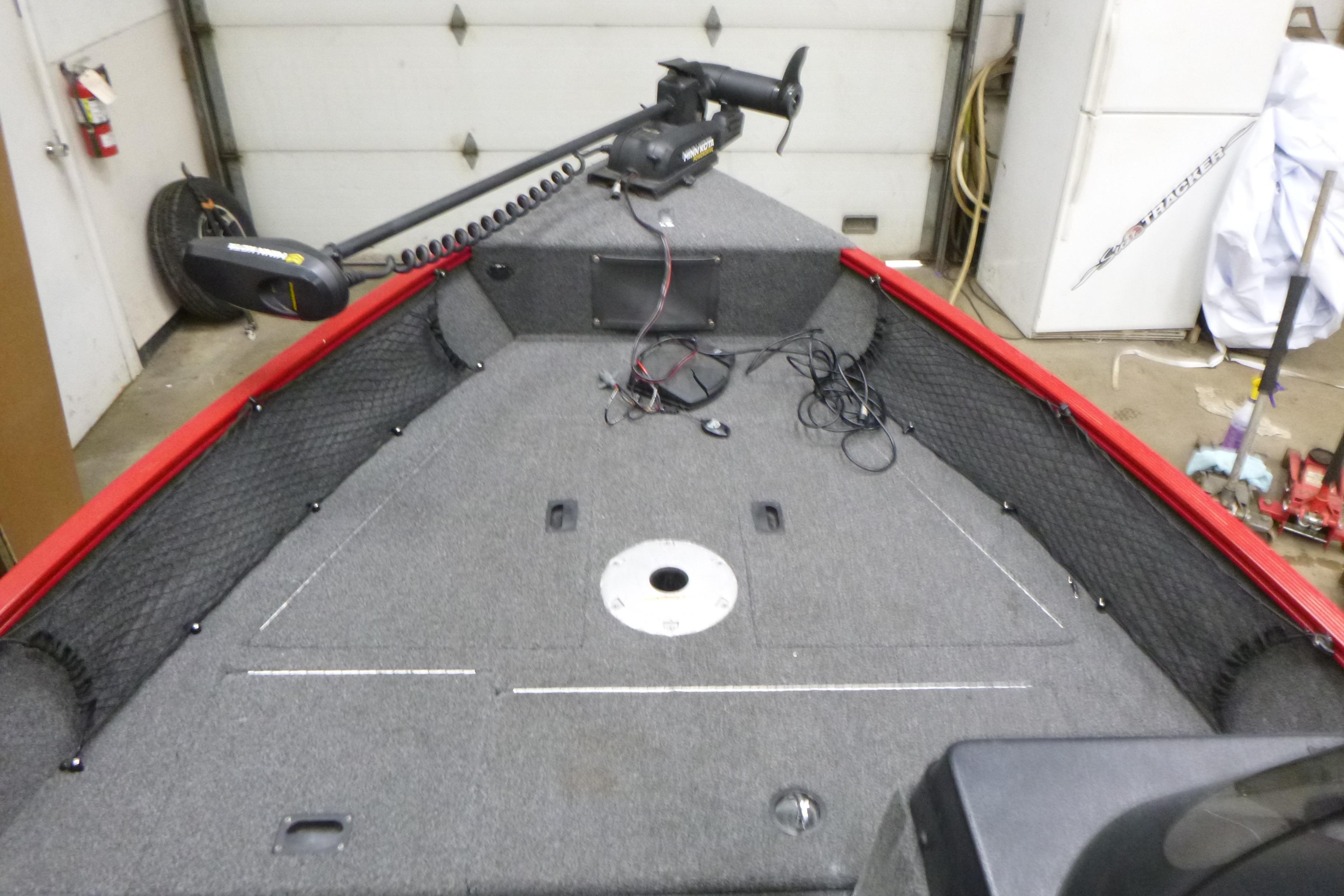 2022 Lund 1650 Angler Sport boat interior with trolling motor in garage.