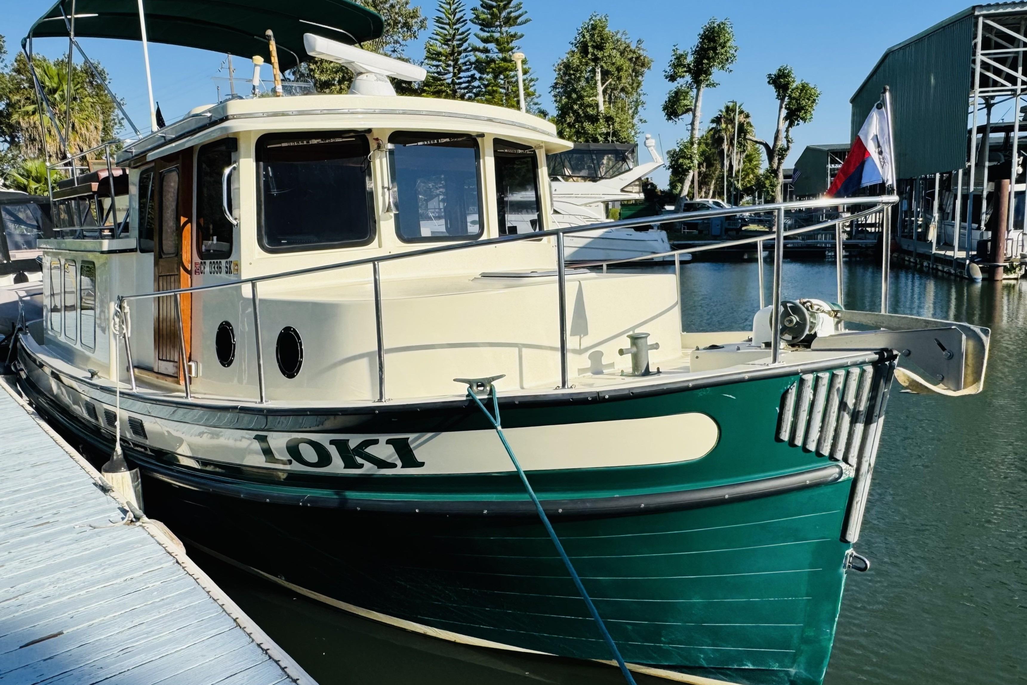 Nordic Tug 32, 1996 model, docked with green and cream exterior, named "Loki".