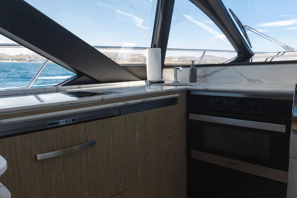 Modern kitchen interior on 2020 Azimut 60 yacht with ocean view.