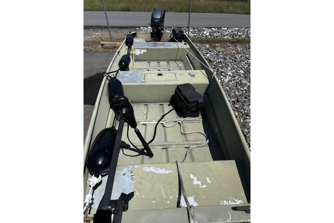 2012 Tracker Topper 1542 LW Riveted Jon boat with motor, parked on gravel.
