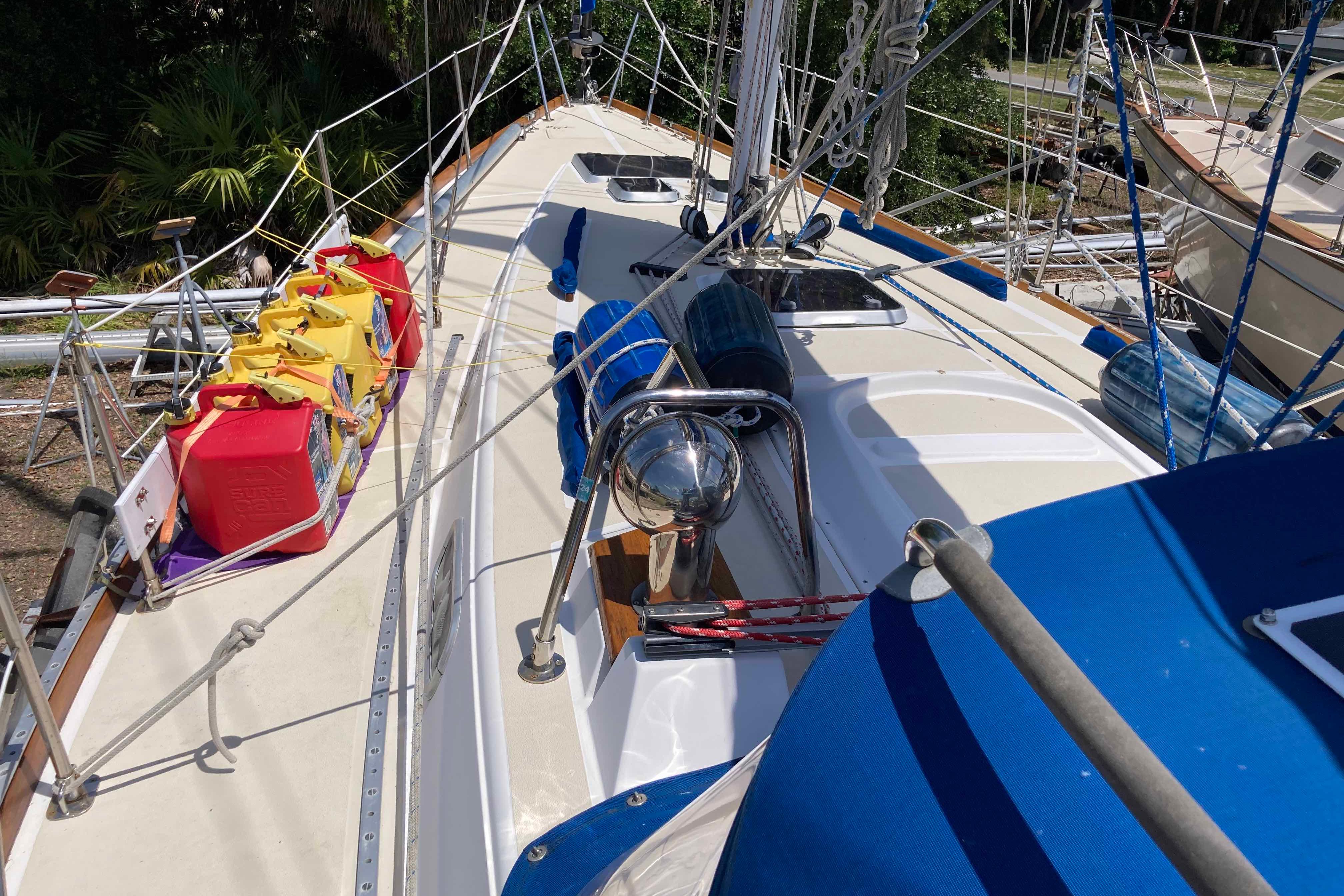 1990 Tartan 372 sailboat deck with colorful fuel containers and rigging.