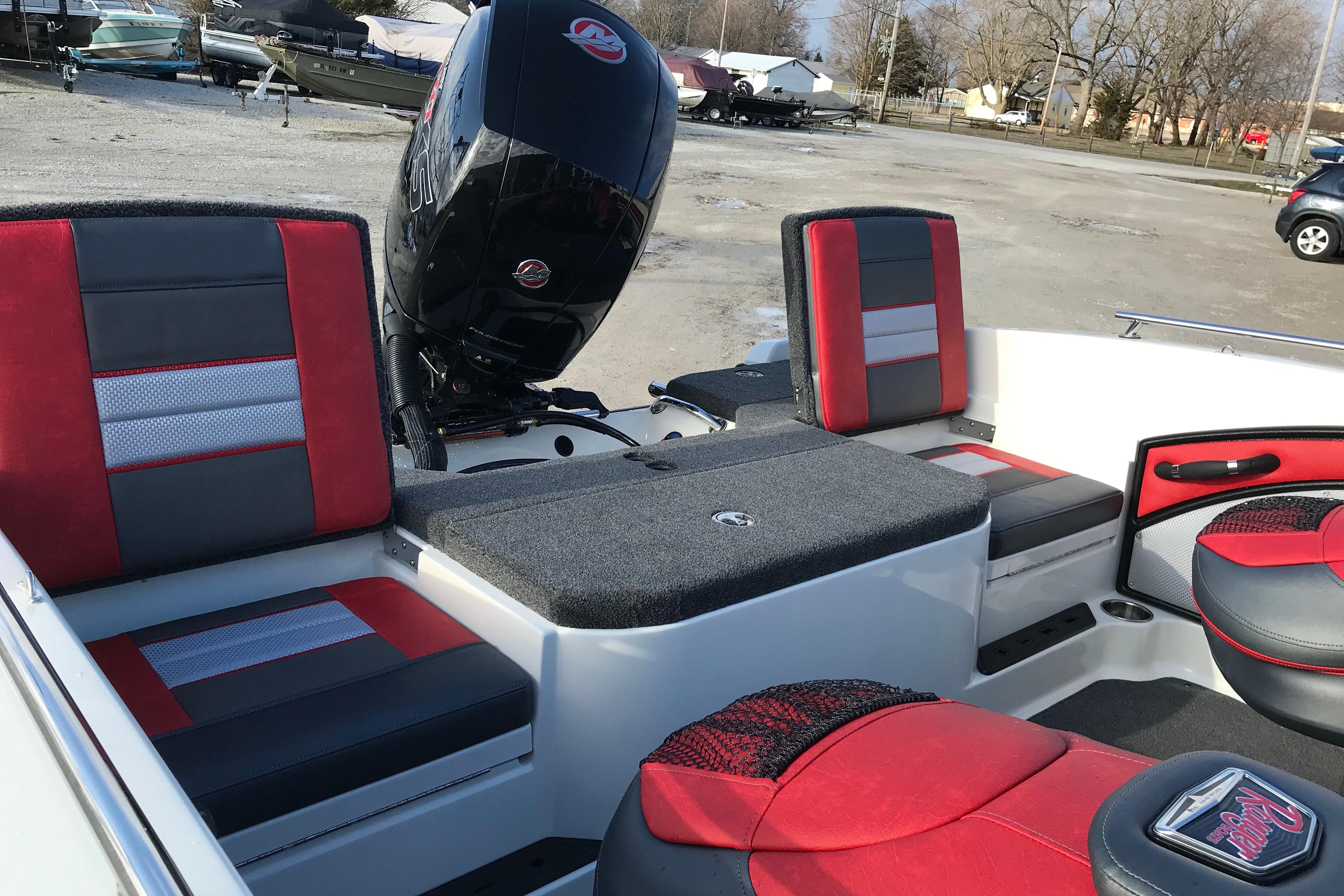 2026 Ranger 1850MS boat interior with red and gray seating, parked outdoors.