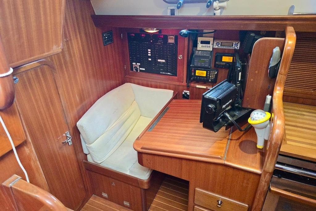 Navigation station of a 2006 Outbound 44 yacht with control panels and seating.