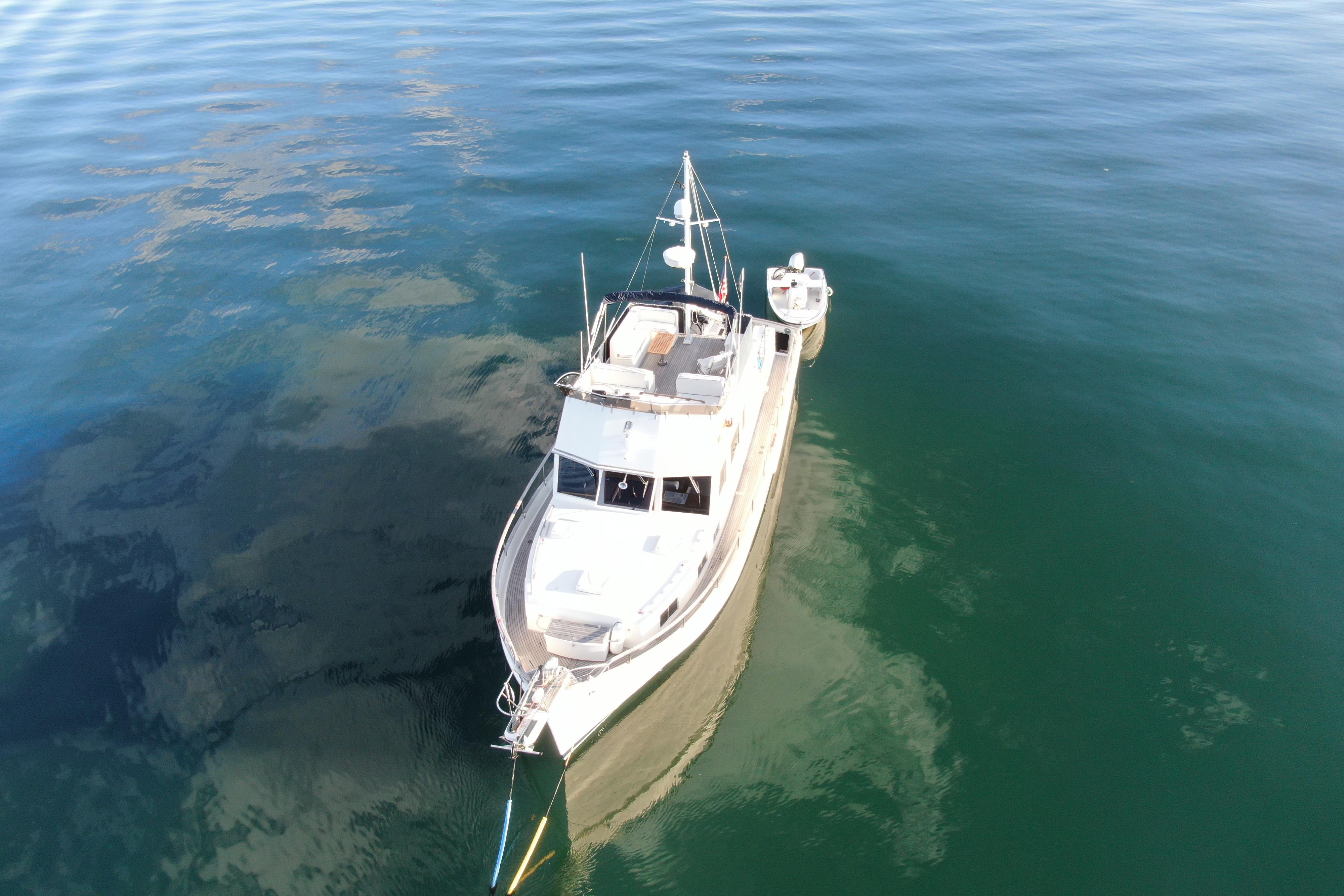 1989 Grand Banks 46 Classic yacht on calm water, aerial view.