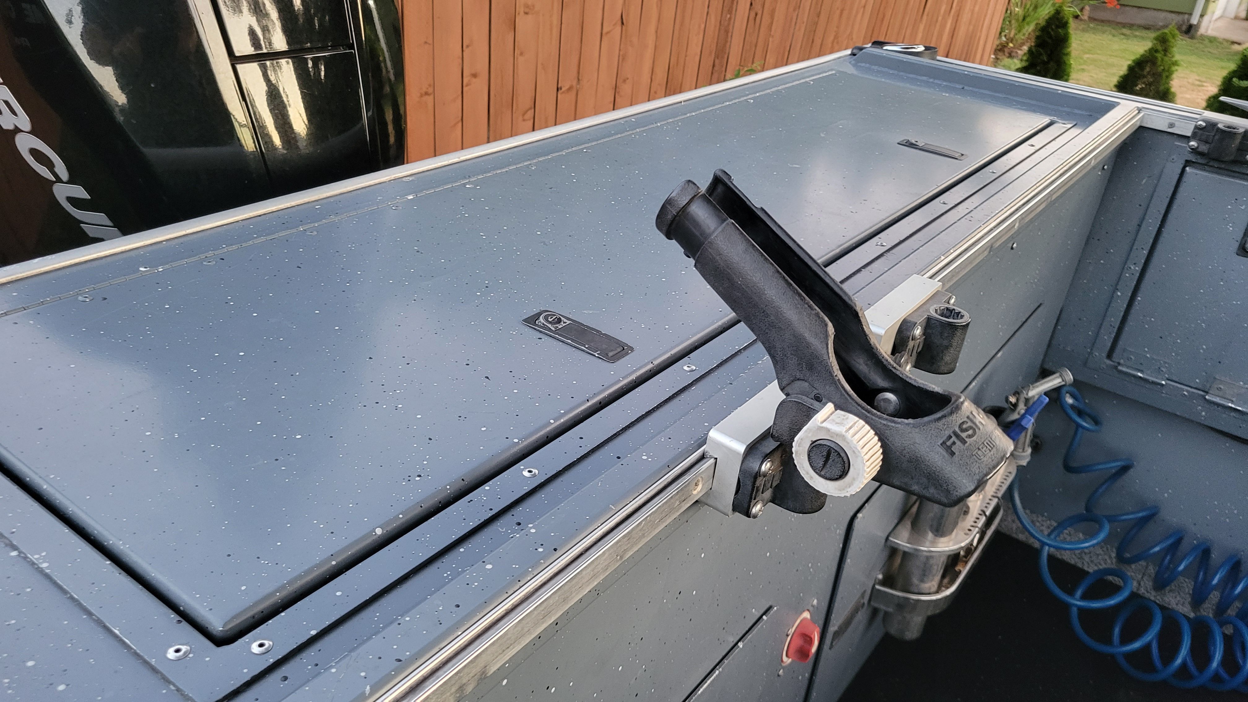 Close-up of a 2015 Alumaweld Formula Vee Outboard 24 with a fishing rod holder.
