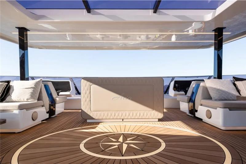 Luxurious 2026 Sunreef 80 Sunreef Power yacht deck with elegant seating and compass design.