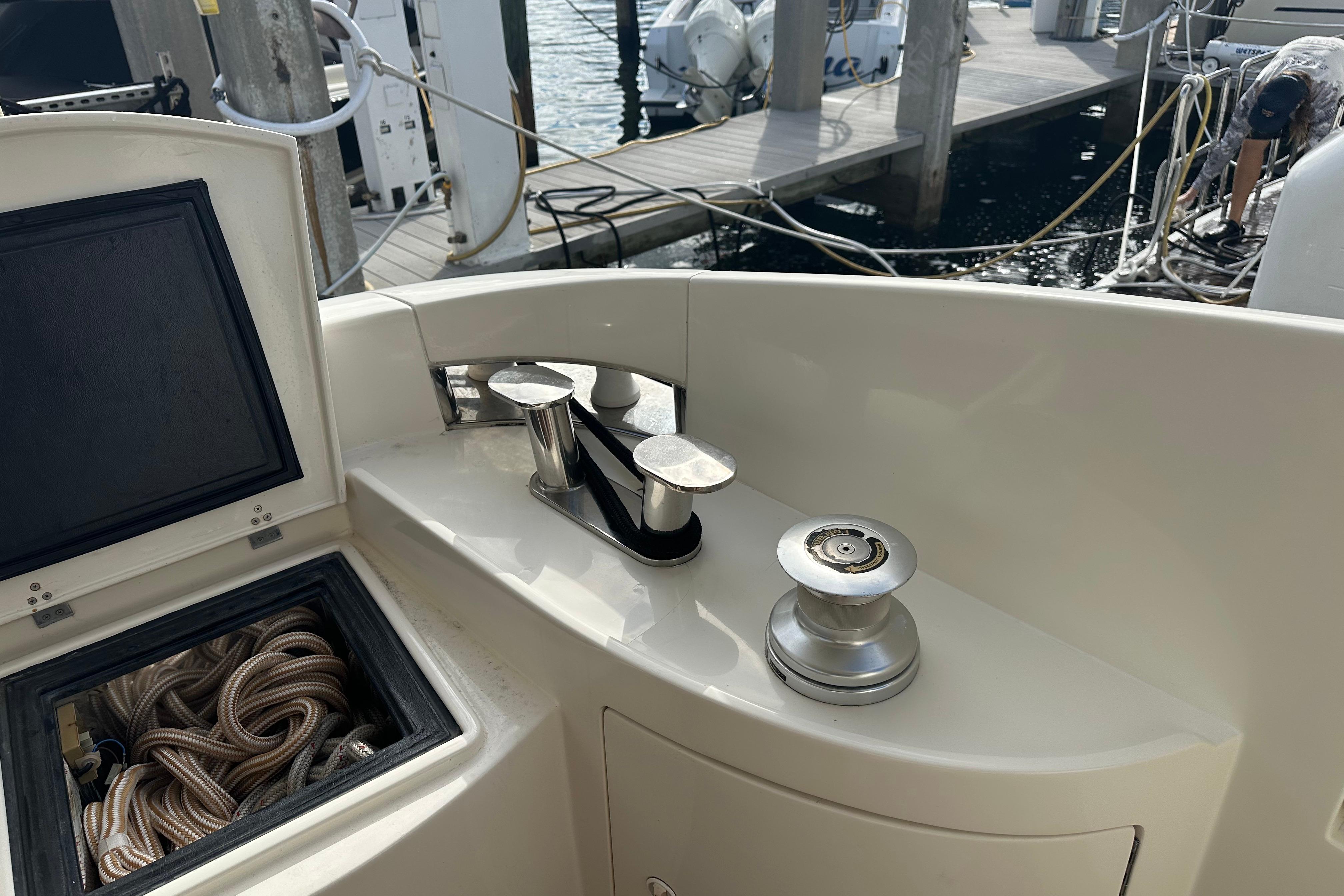 Deck of 2004 Azimut 55E yacht with mooring equipment and storage compartment.