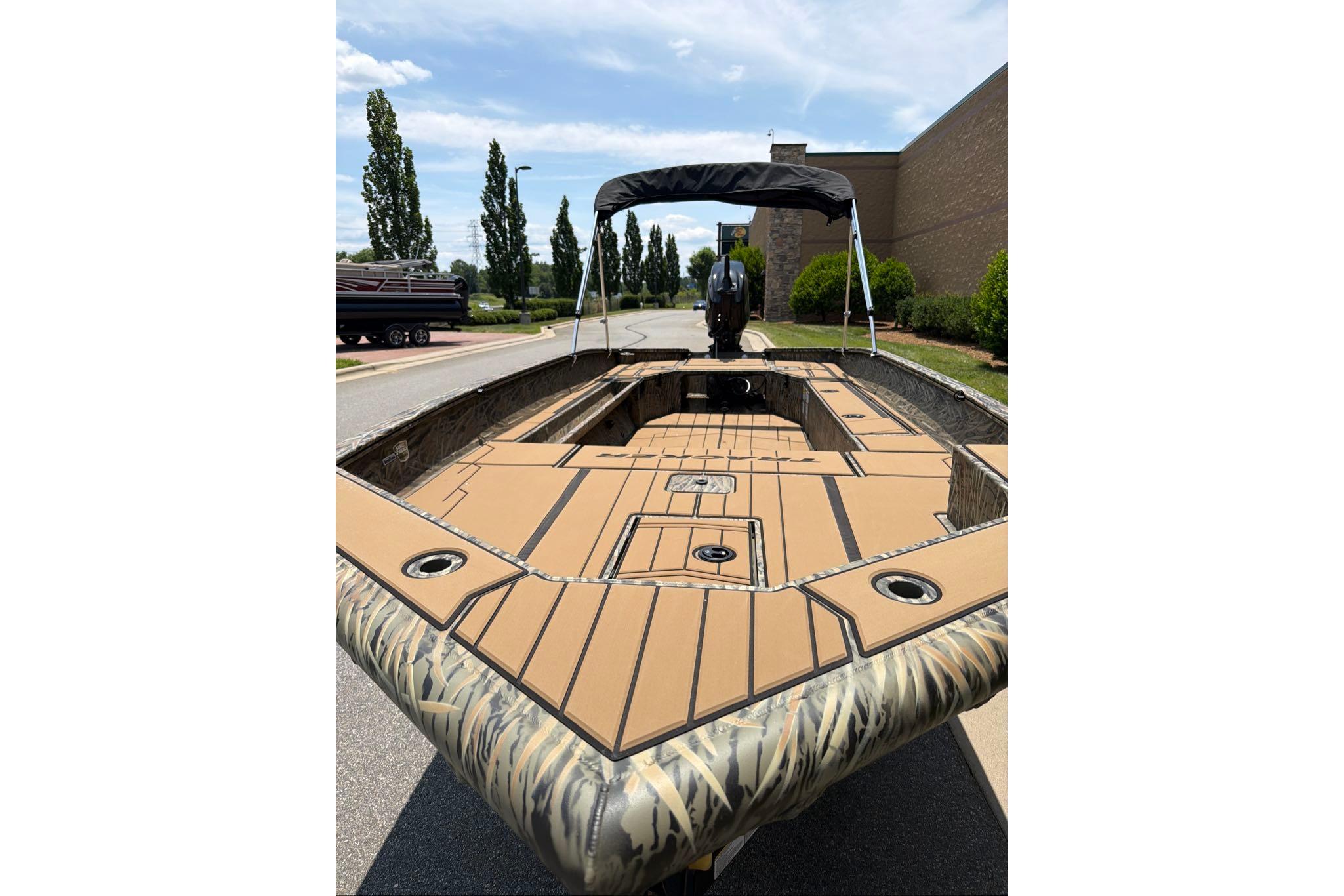2026 Tracker Grizzly 1756 T Marsh boat with camouflage design and spacious deck.