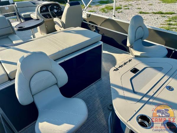2025 South Bay 224FCR LE pontoon boat interior with beige seating and steering console.