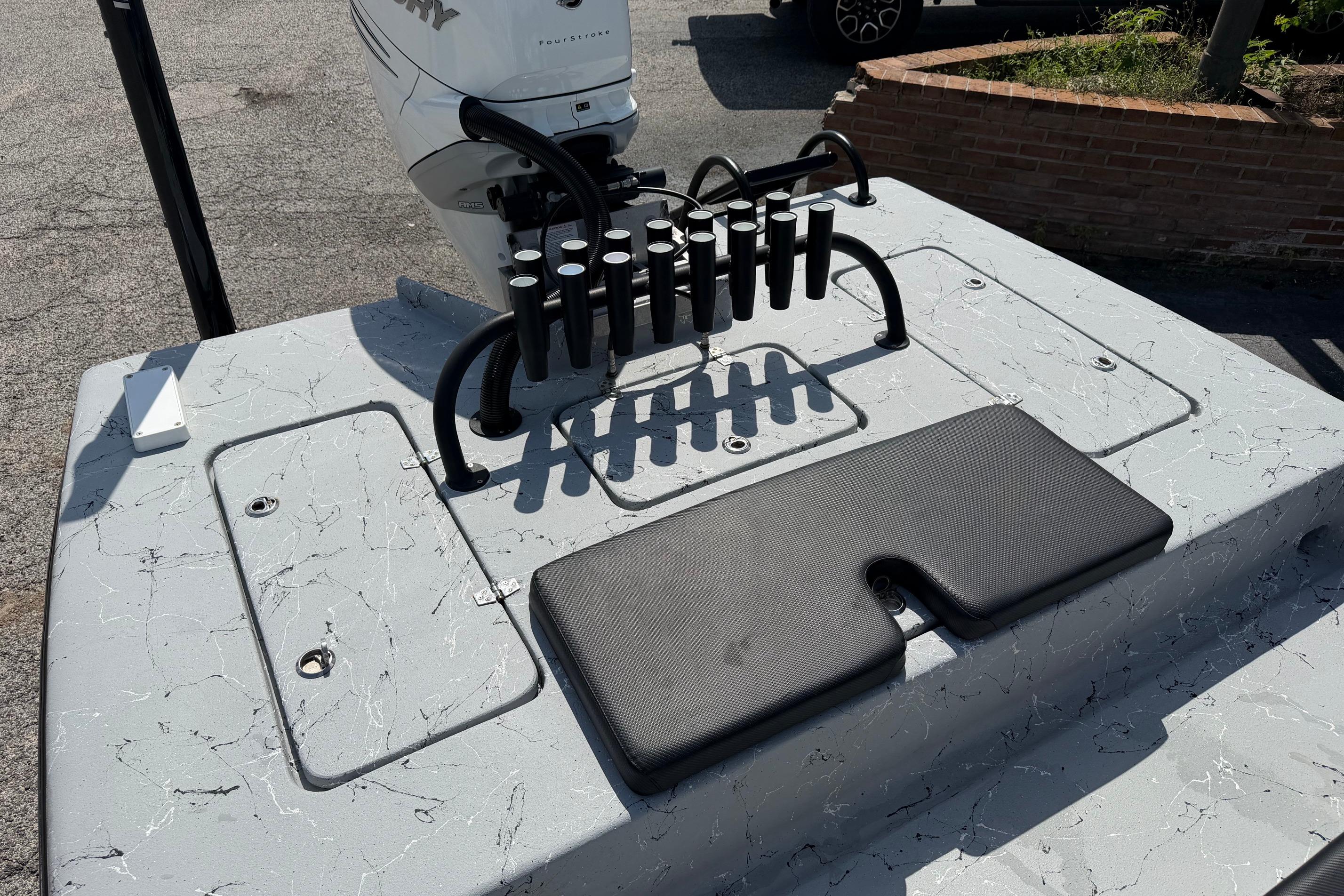 2023 Haynie 23 Super Cat boat deck with rod holders and Mercury engine.