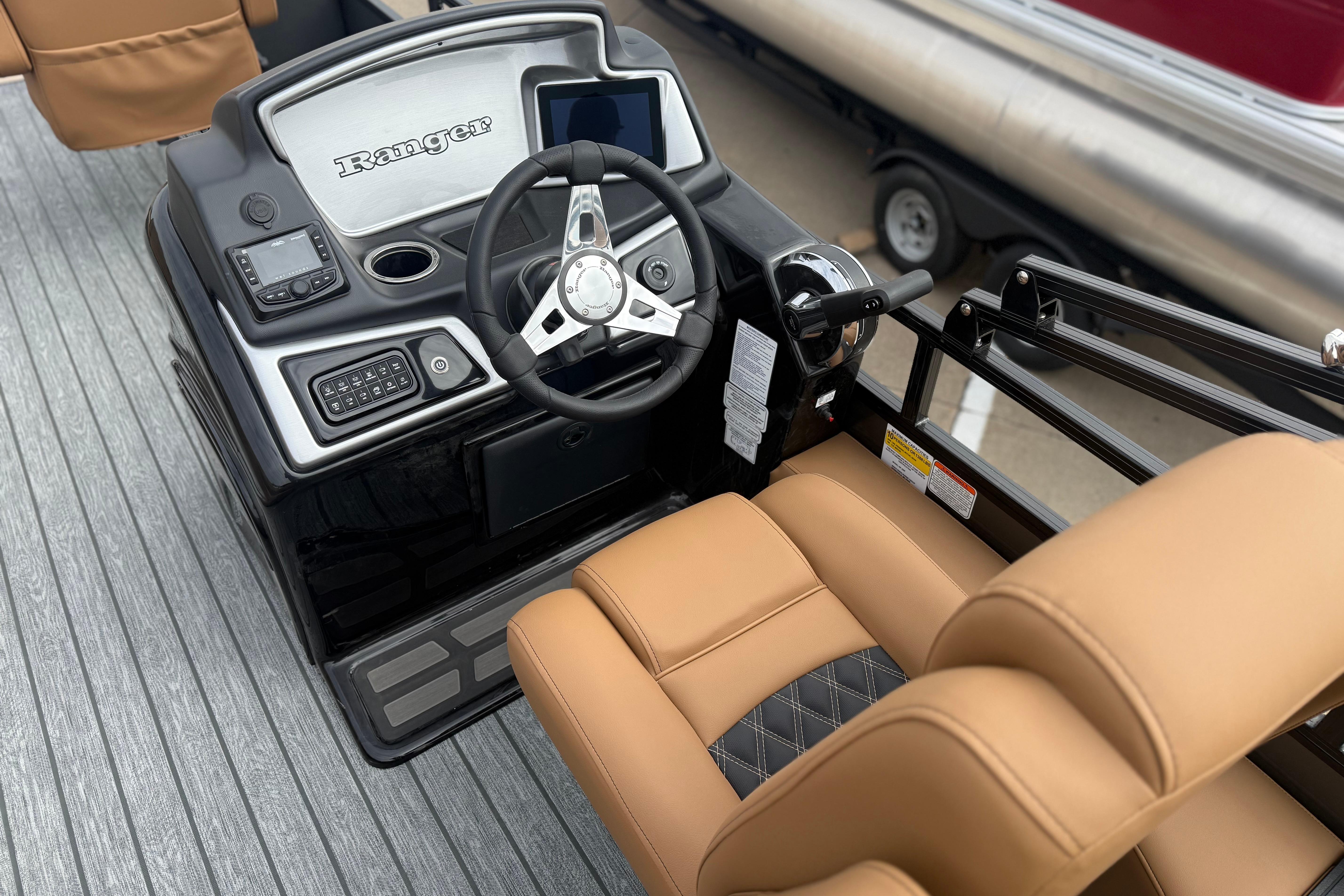 2026 Ranger 220F boat dashboard with steering wheel and tan seating.