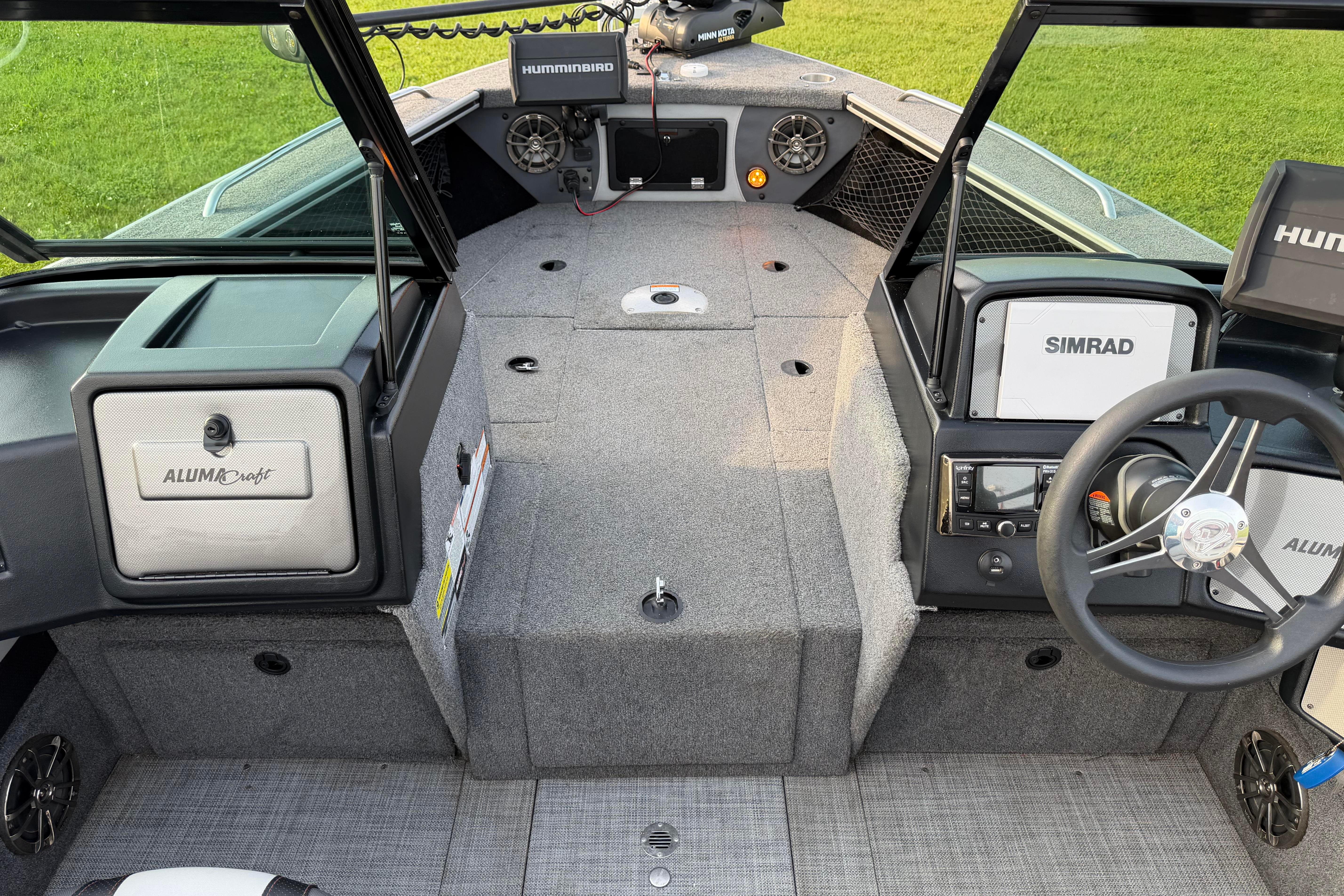 2019 Alumacraft Trophy 205 boat interior with steering wheel, Simrad and Humminbird electronics.
