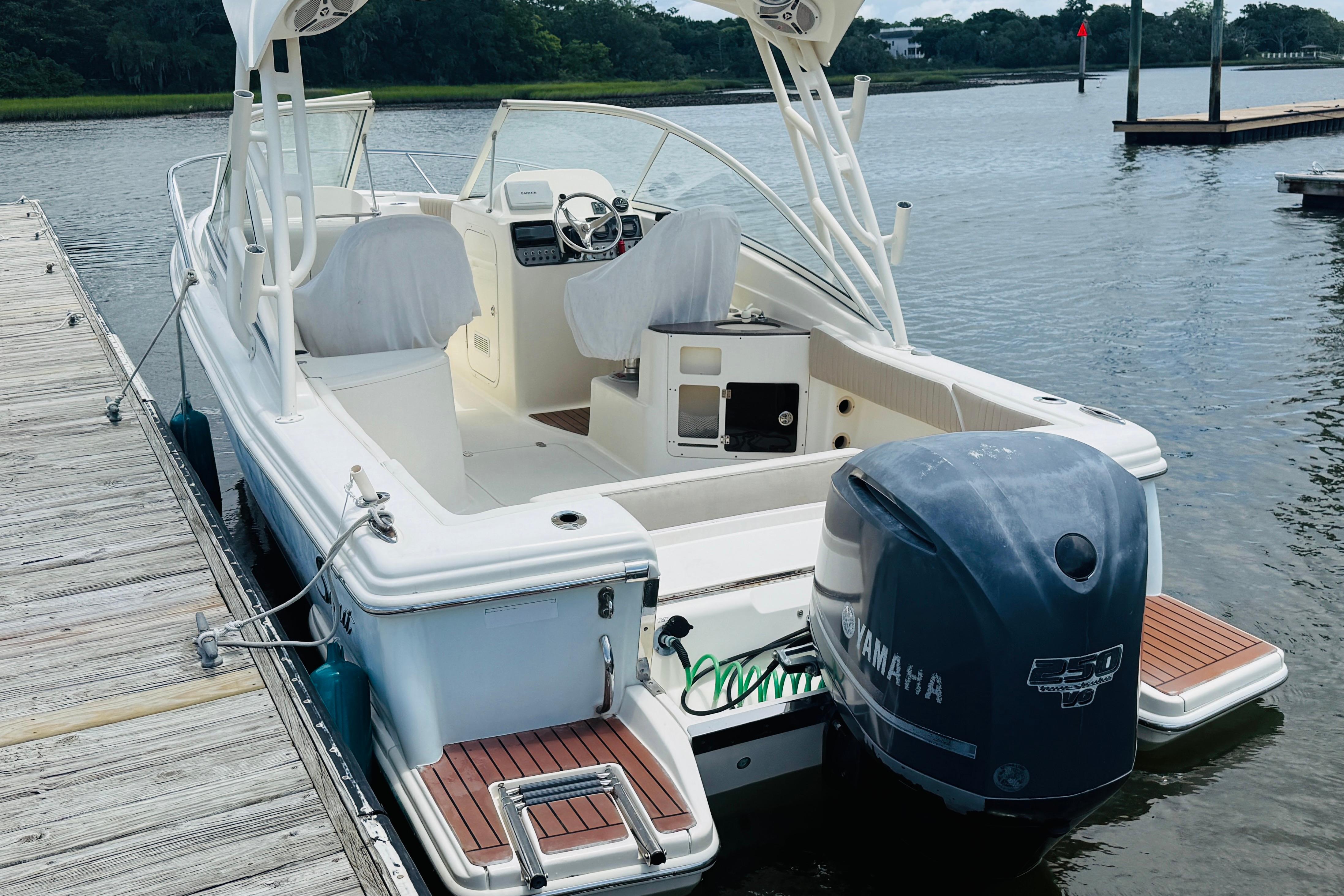 2012 Scout 245 Dorado boat docked with Yamaha outboard motor.