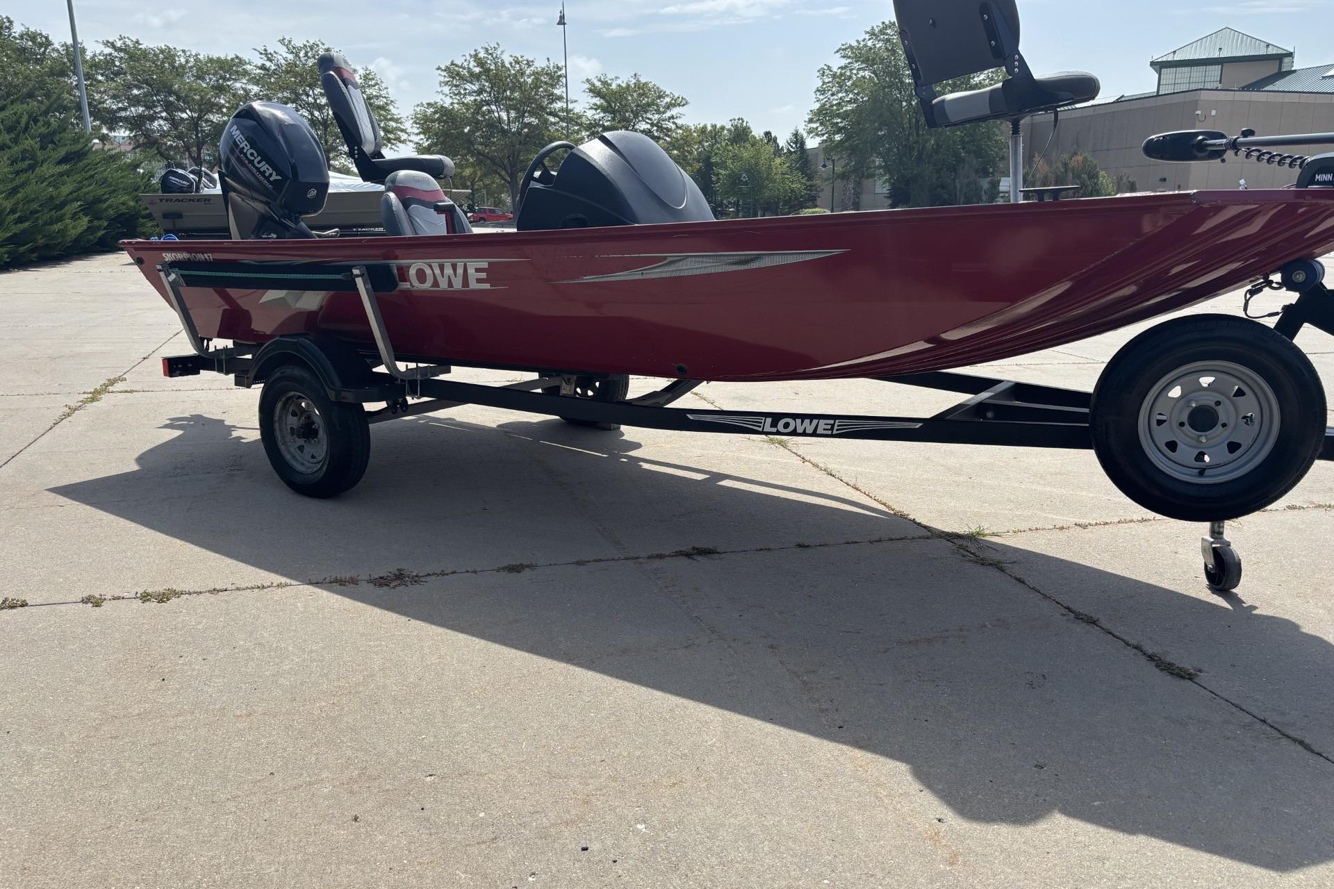2019 Lowe Skorpion 17 boat on trailer, red exterior, parked outdoors.