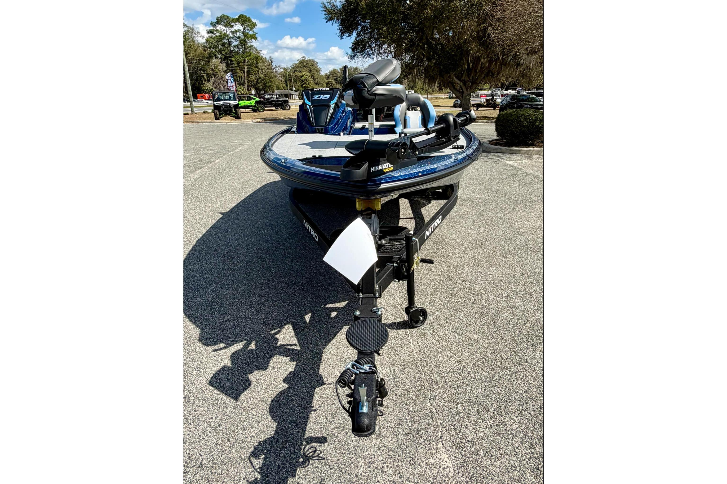 2026 Nitro Z18 boat on trailer, parked outdoors under a clear blue sky.