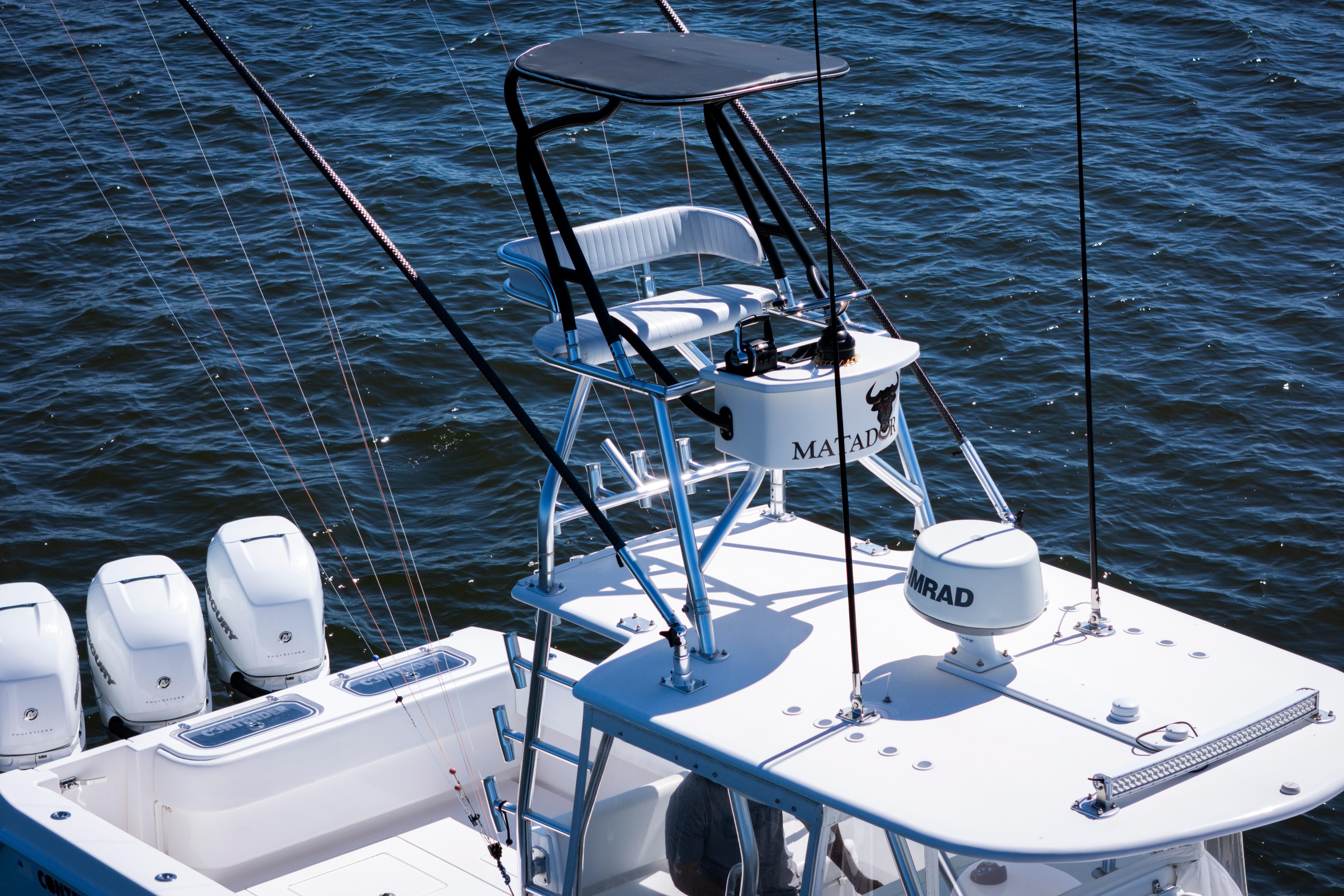 2015 Contender 39 ST boat with tower and multiple outboard engines on the water.
