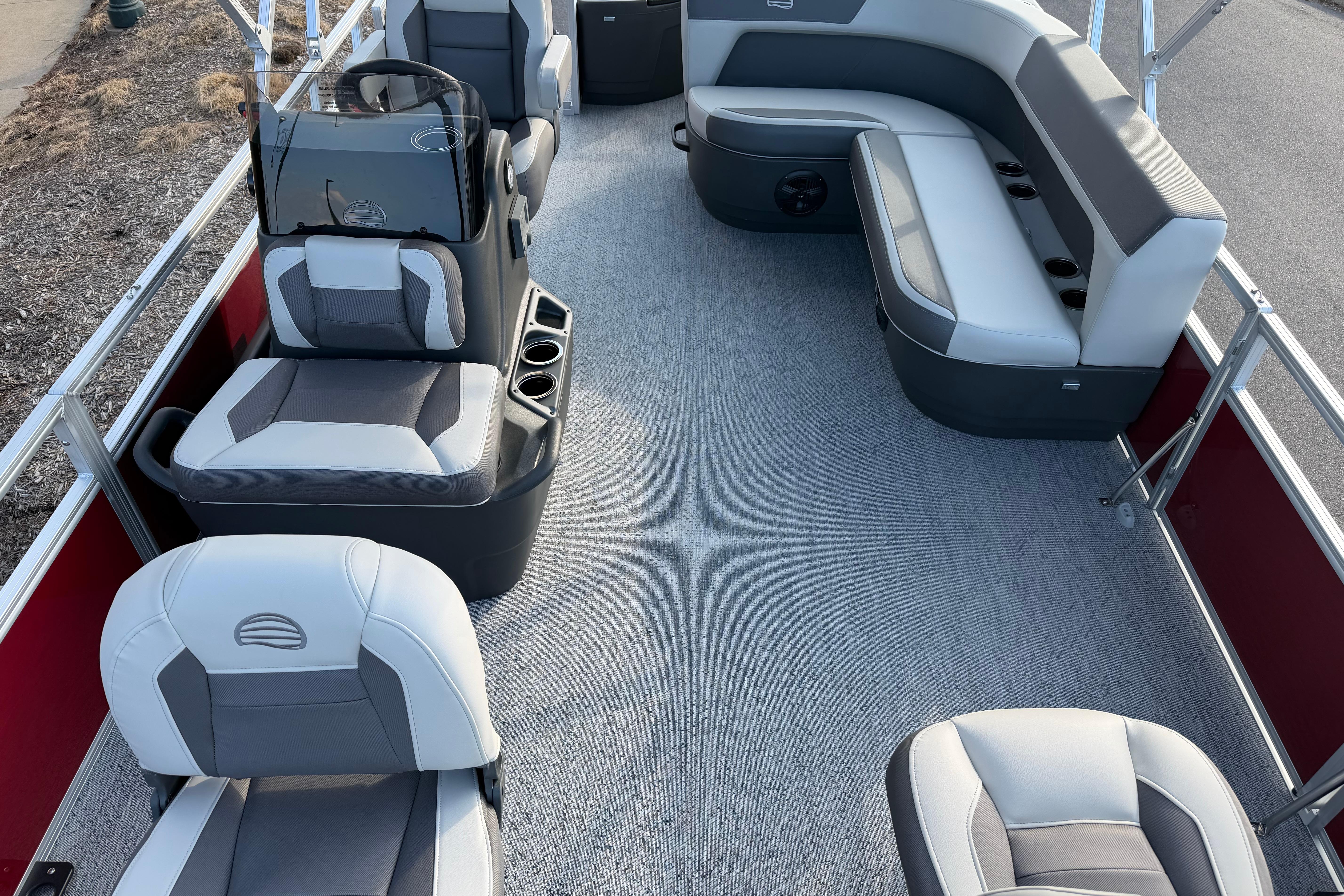 2026 Sun Tracker Bass Buggy 18 DLX pontoon boat interior with gray seating and red accents.