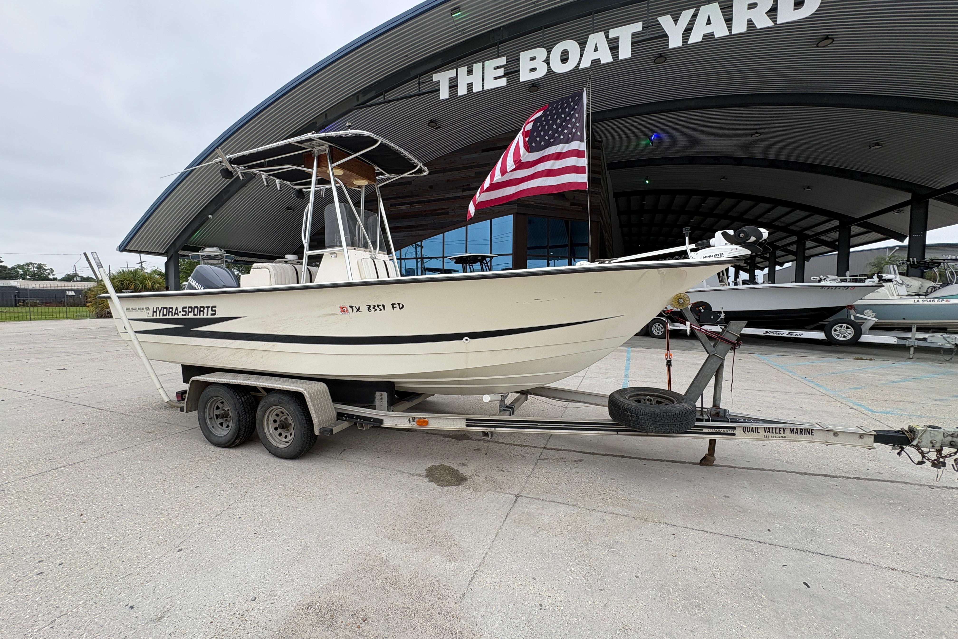 1998 Hydra-Sports 22 Ocean CC boat on trailer at The Boat Yard, displaying American flag.