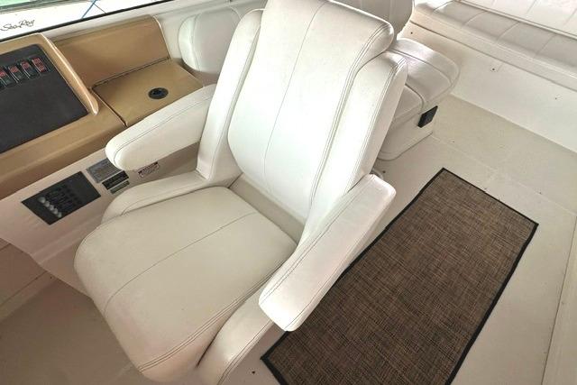 Captain's chair on 2004 Carver 360 Mariner yacht, featuring white upholstery and control panel.