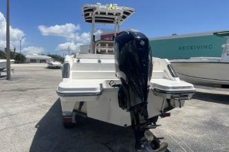 2023 Trophy T24 CC boat with outboard motor in a sunny marina setting.