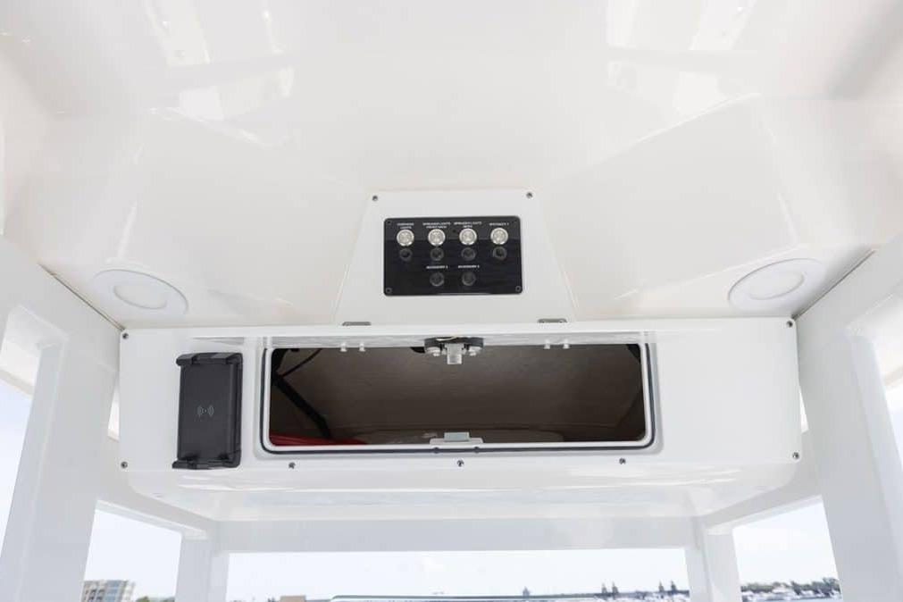 Overhead console of 2027 Sea Fox 231 Bay Fox boat with storage compartment and control panel.