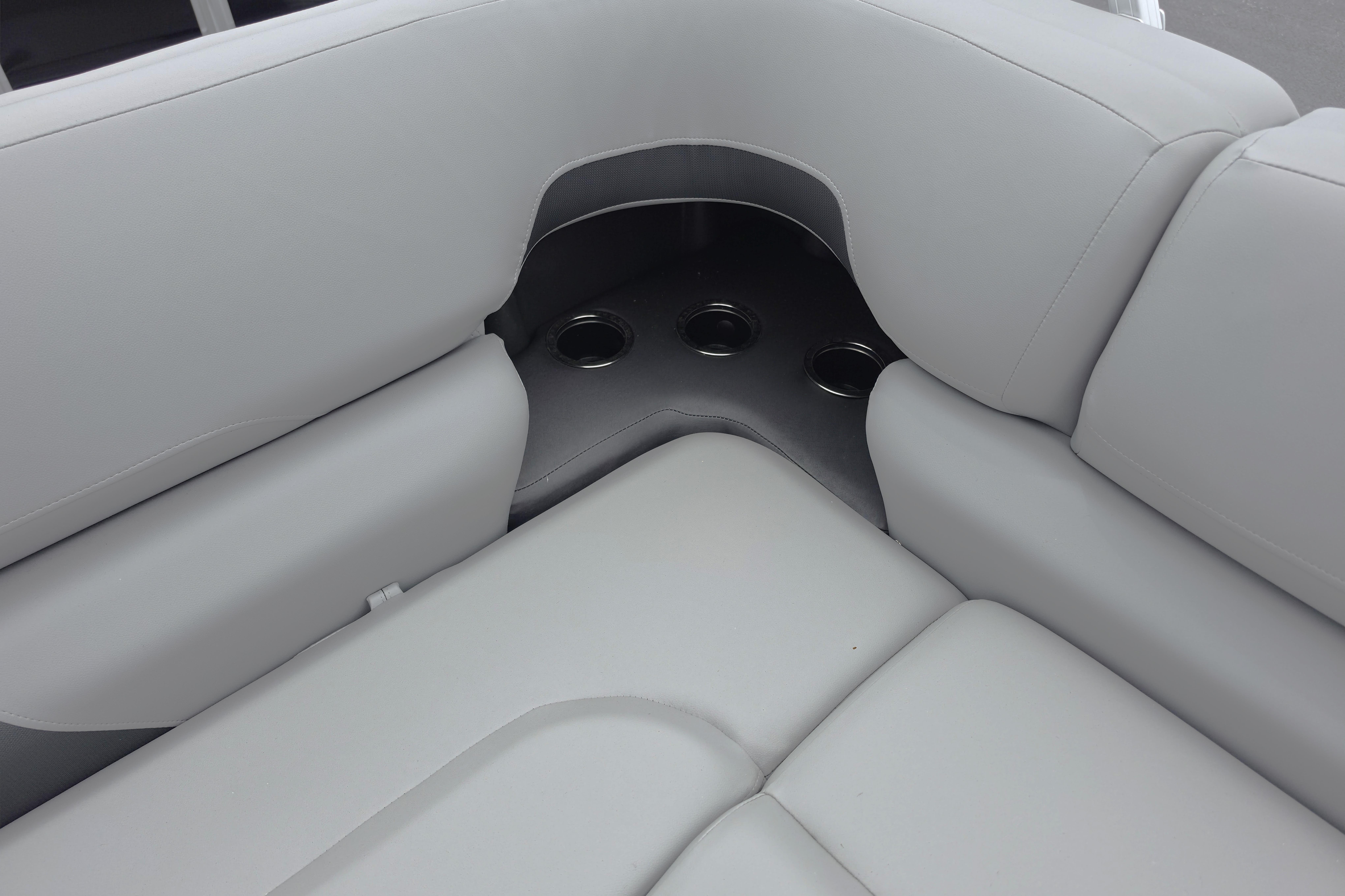 2026 Sun Tracker SportFish 22 XP3 boat interior with cushioned seating and cup holders.