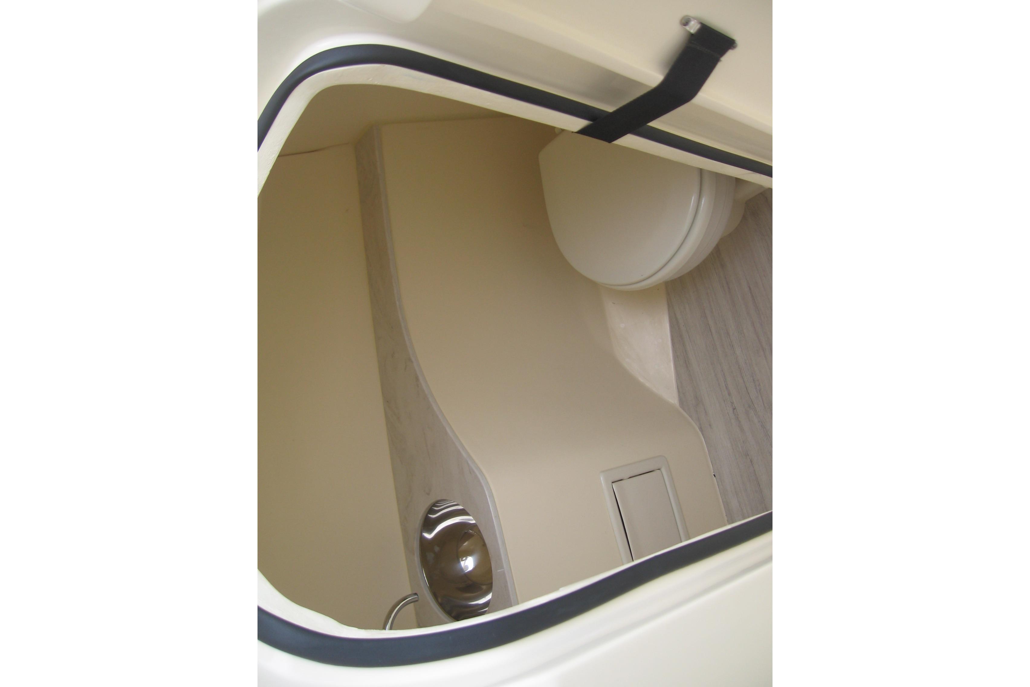 2024 Scout 255 Dorado interior cabin with compact toilet and sleek design.